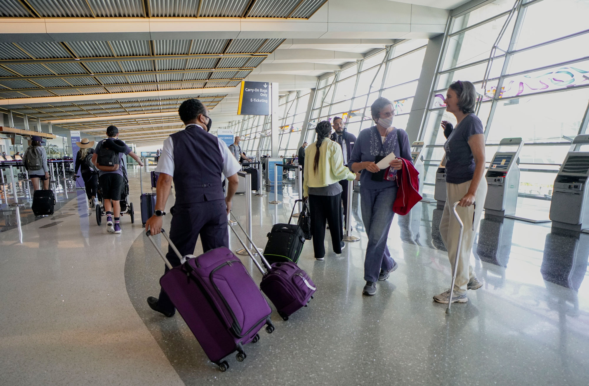 Passengers check in for their flights at San Diego International Airport on May 20 in San Diego.