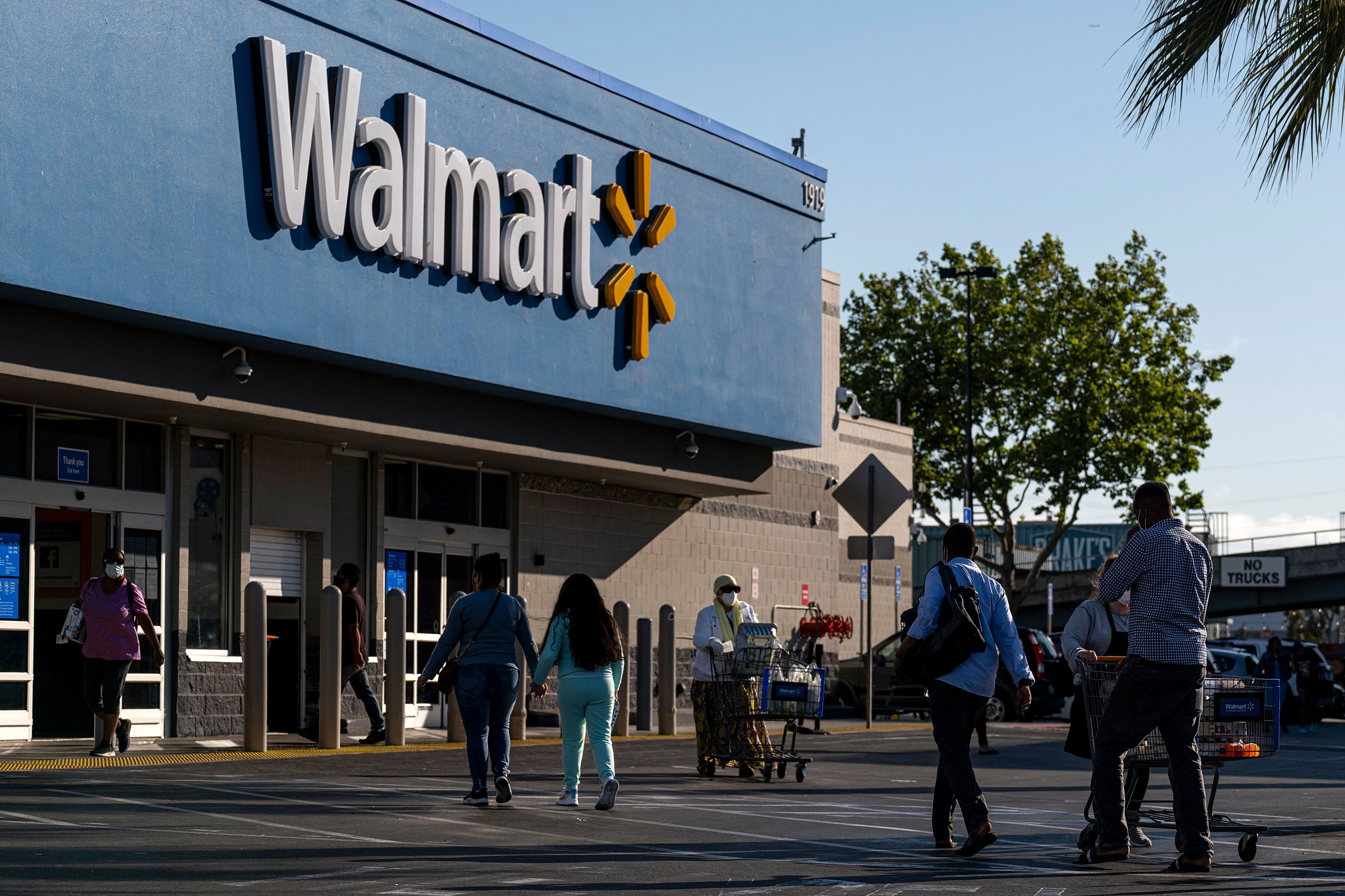 People walk in front of a Walmart store in San Leandro, California, on May 13.