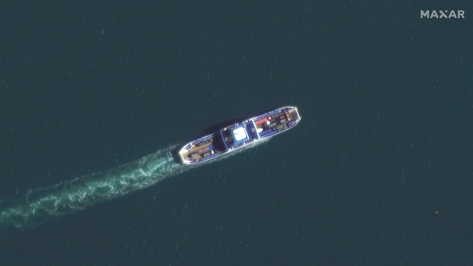 A satellite image of a ferry carrying trucks across the Kerch Strait is seen on October 12. 