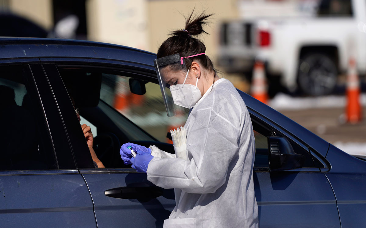 A tester prepares to administer a swab test at a drive-in COVID-19 testing site in Federal Heights, Colorado, on October 27.