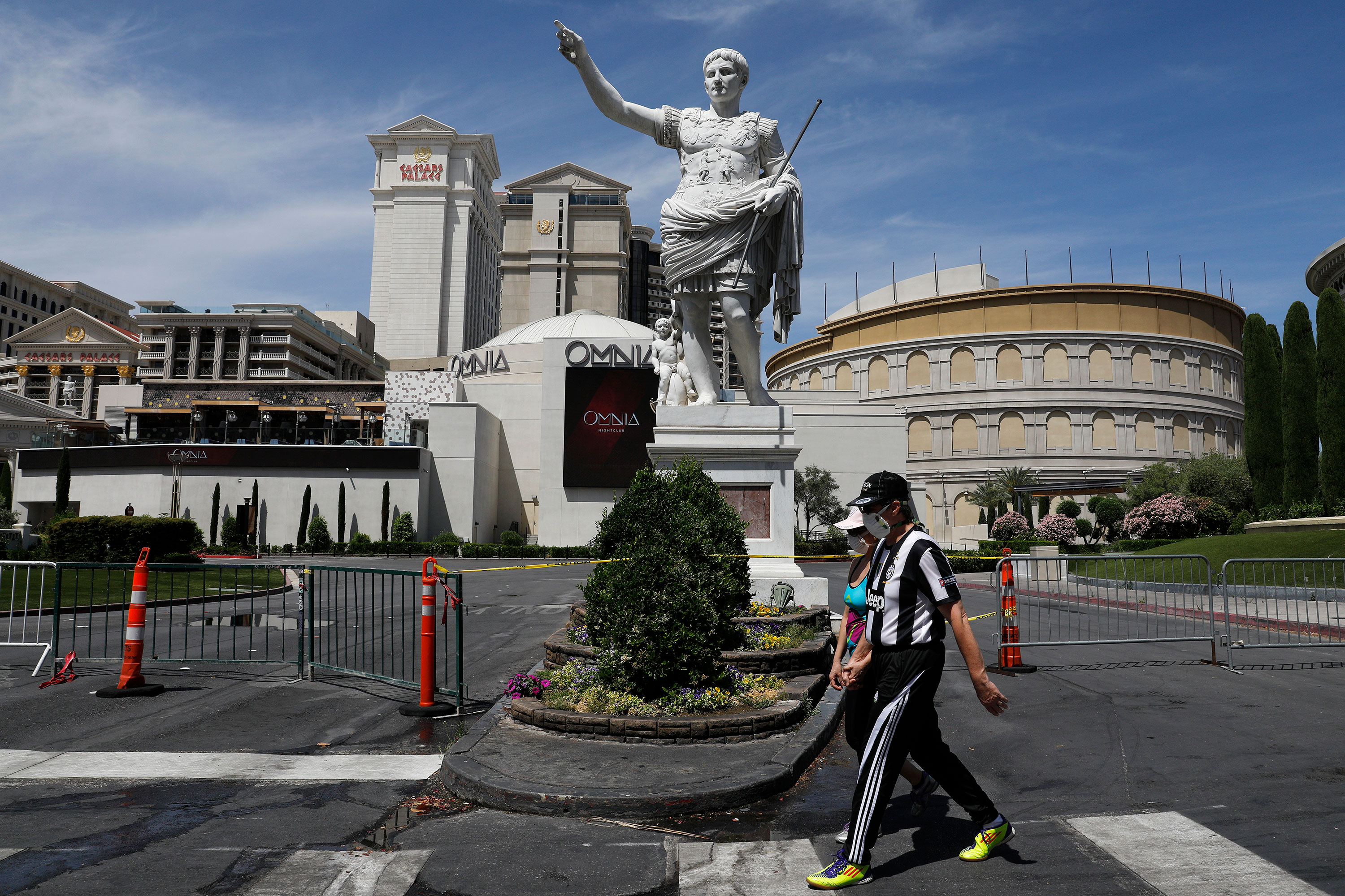 People walk in front of Caesars Palace in Las Vegas on May 9.