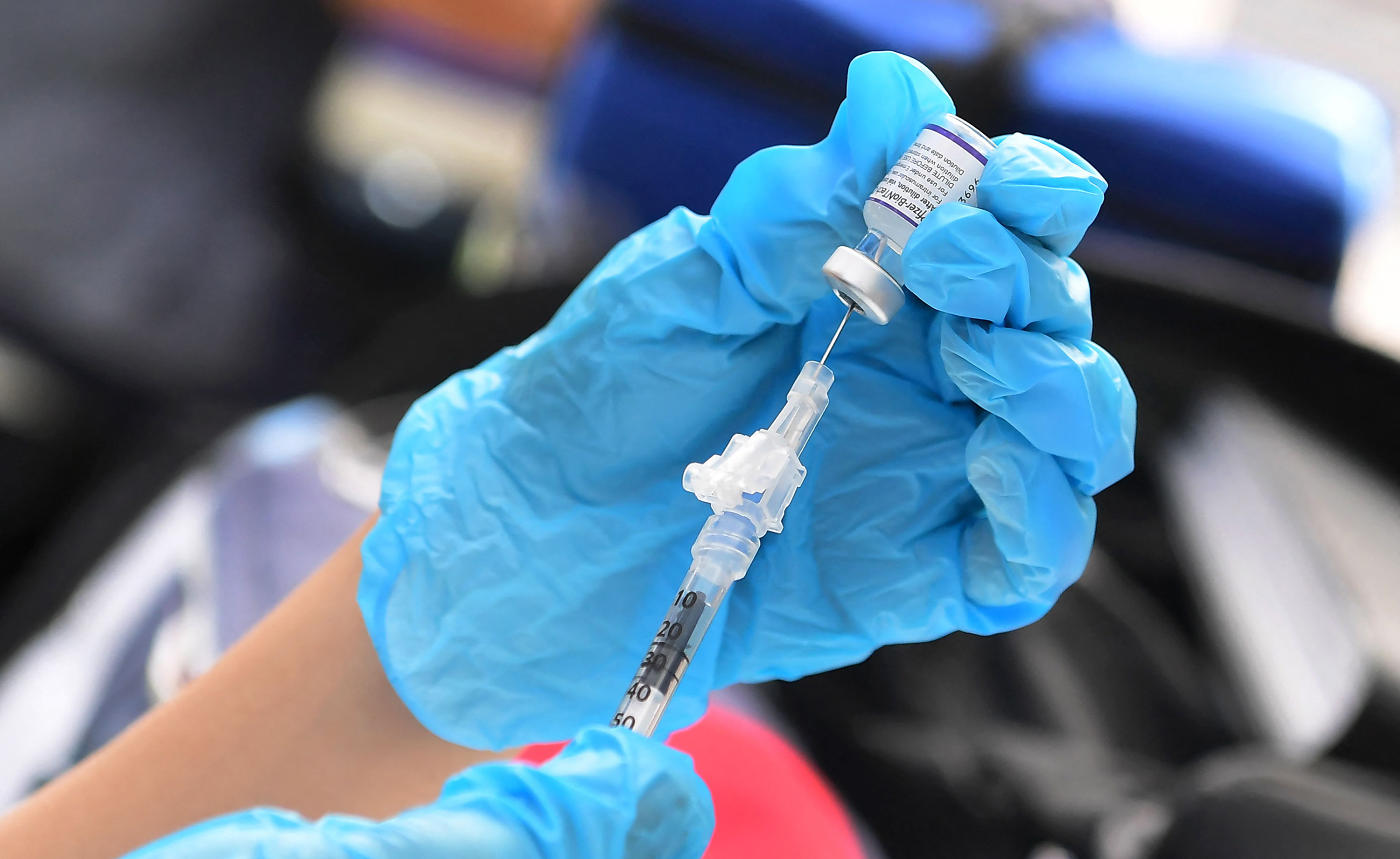 A Pfizer Covid-19 vaccine is prepared for administration at a vaccination clinic on September 22 in Los Angeles.