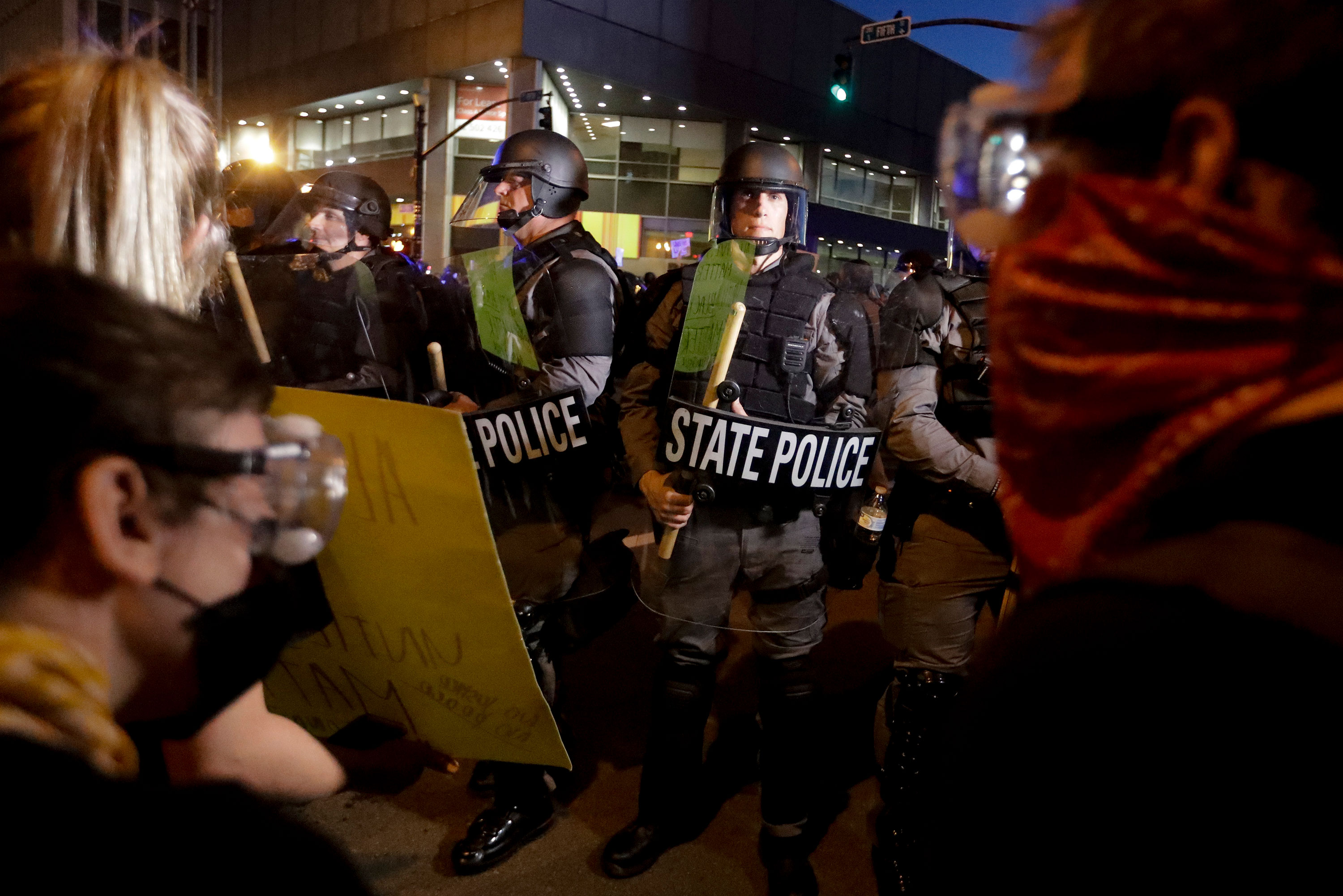 Protesters stand in front of Kentucky State Police officers in Louisville, Kentucky, on May 29.