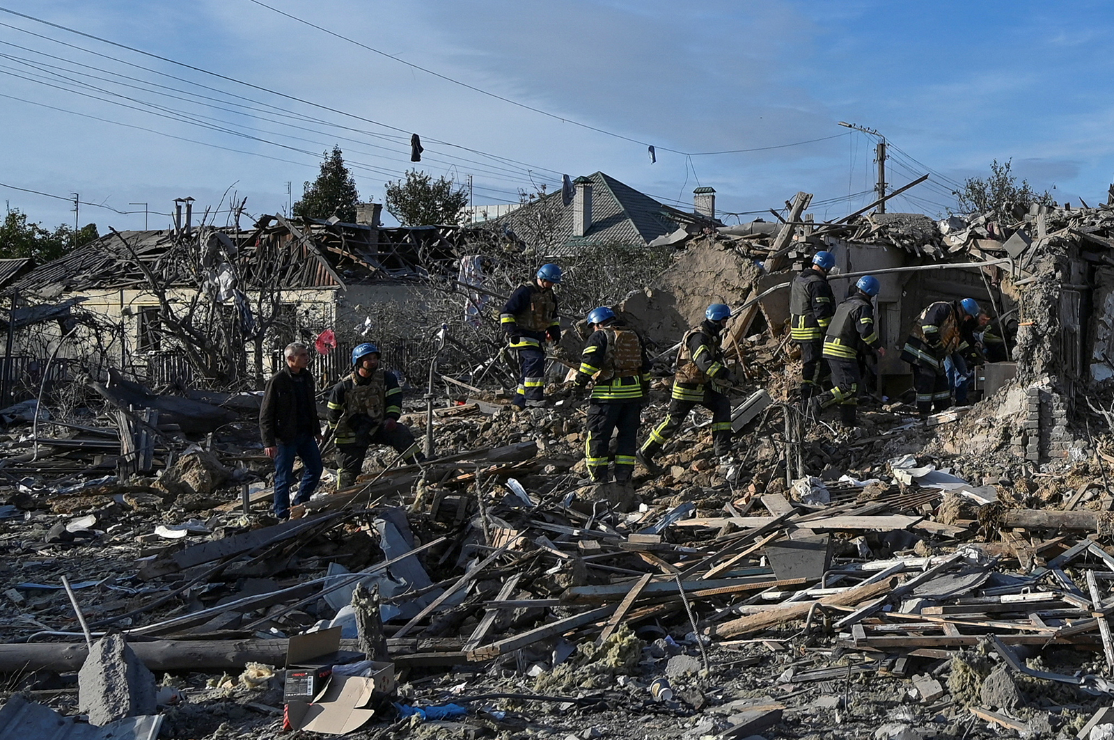 Rescuers work at a site of a residential area heavily damaged by a Russian missile strike in Zaporizhzhia on October 9.