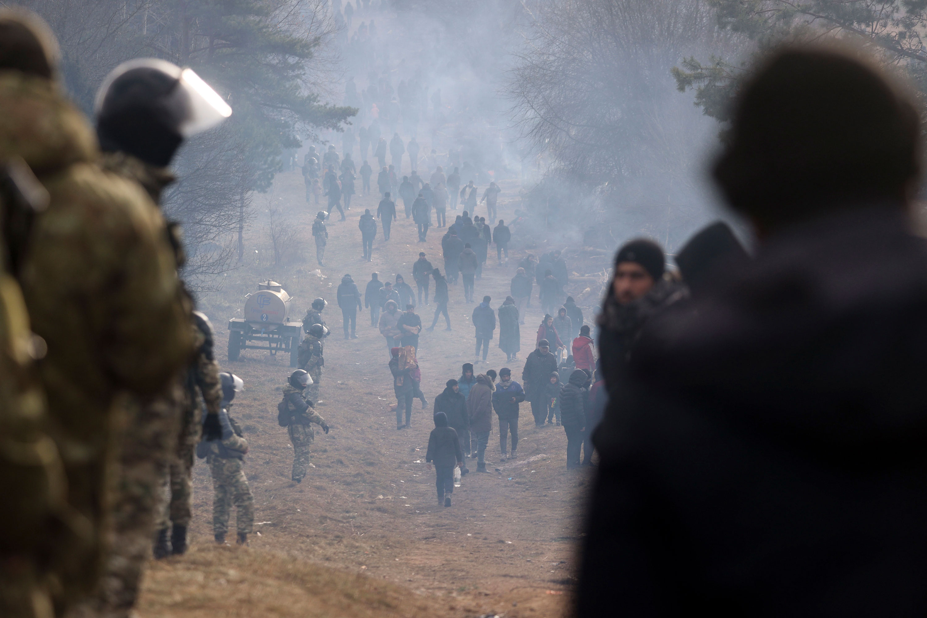 Belarusian servicemen guard an area as migrants gather at the Belarus-Poland border near Grodno, Belarus, on Friday.