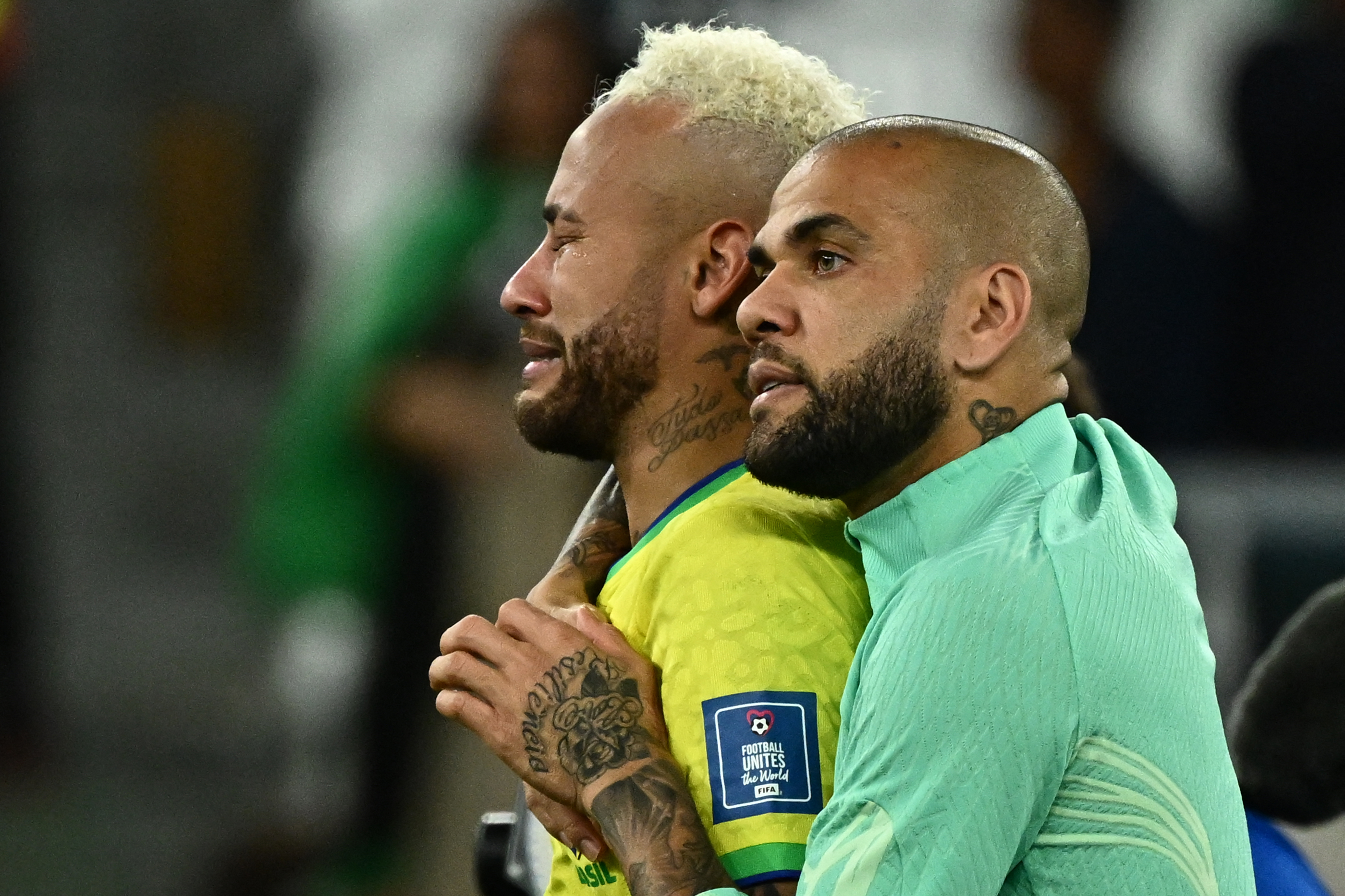 Brazil's Neymar is comforted by teammate Dani Alves as he cries after losing in the penalty shoot-out for the quarter-final match between Croatia and Brazil at Education City Stadium in Al-Rayyan, Qatar on December 9.