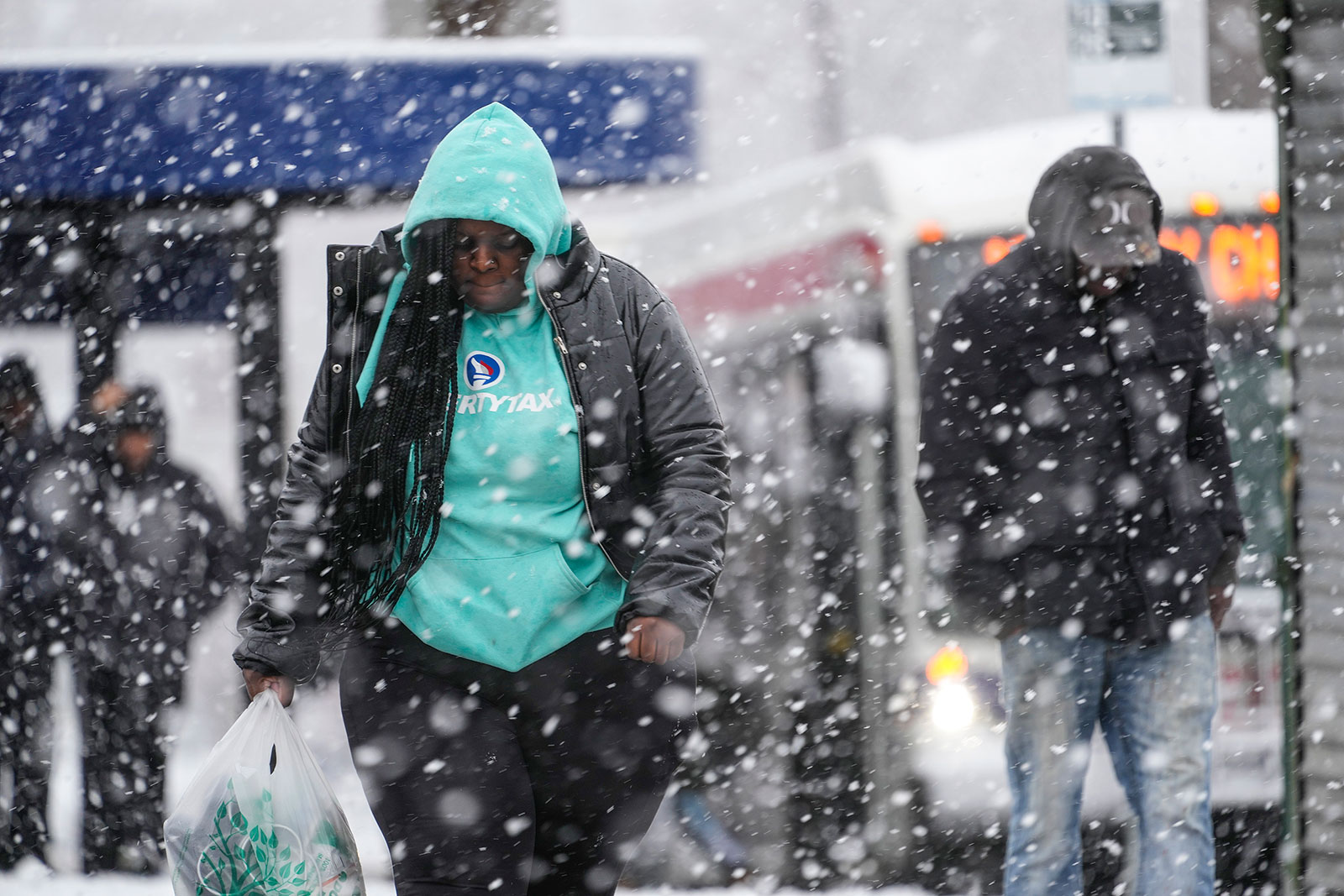 People walk during a winter snow storm in Philadelphia on Tuesday.