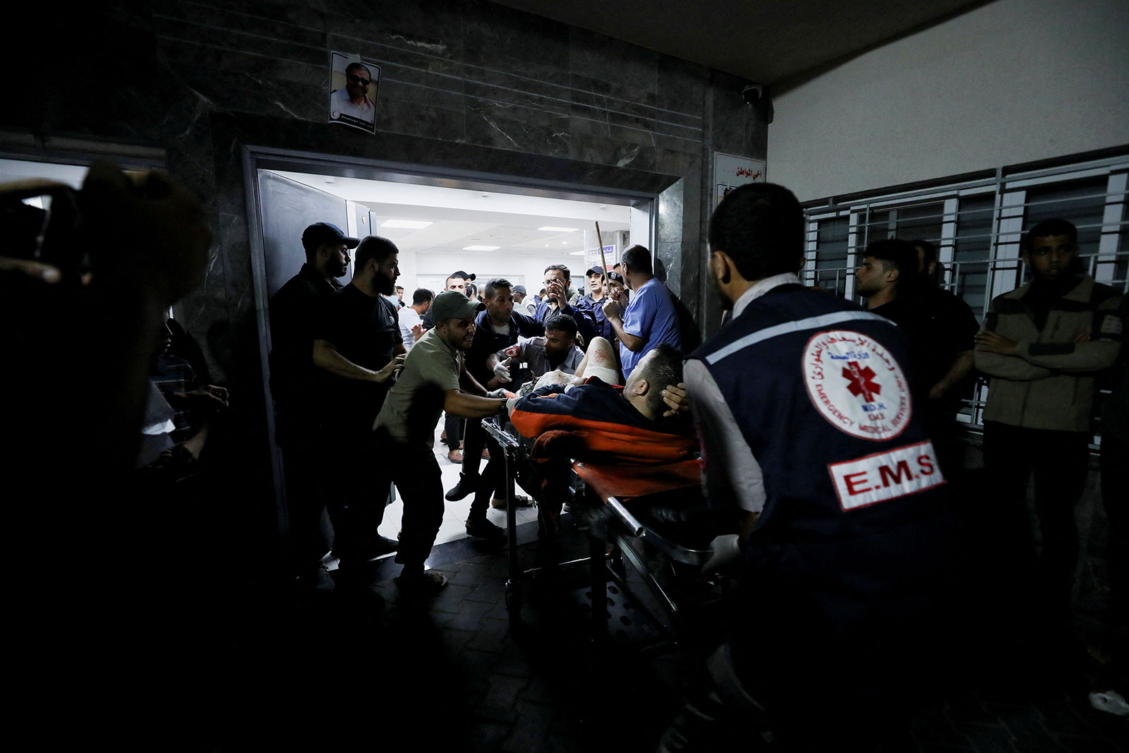 An injured person is assisted after what Palestinian officials are calling an Israeli air strike hit a hospital, on Tuesday, October 17.