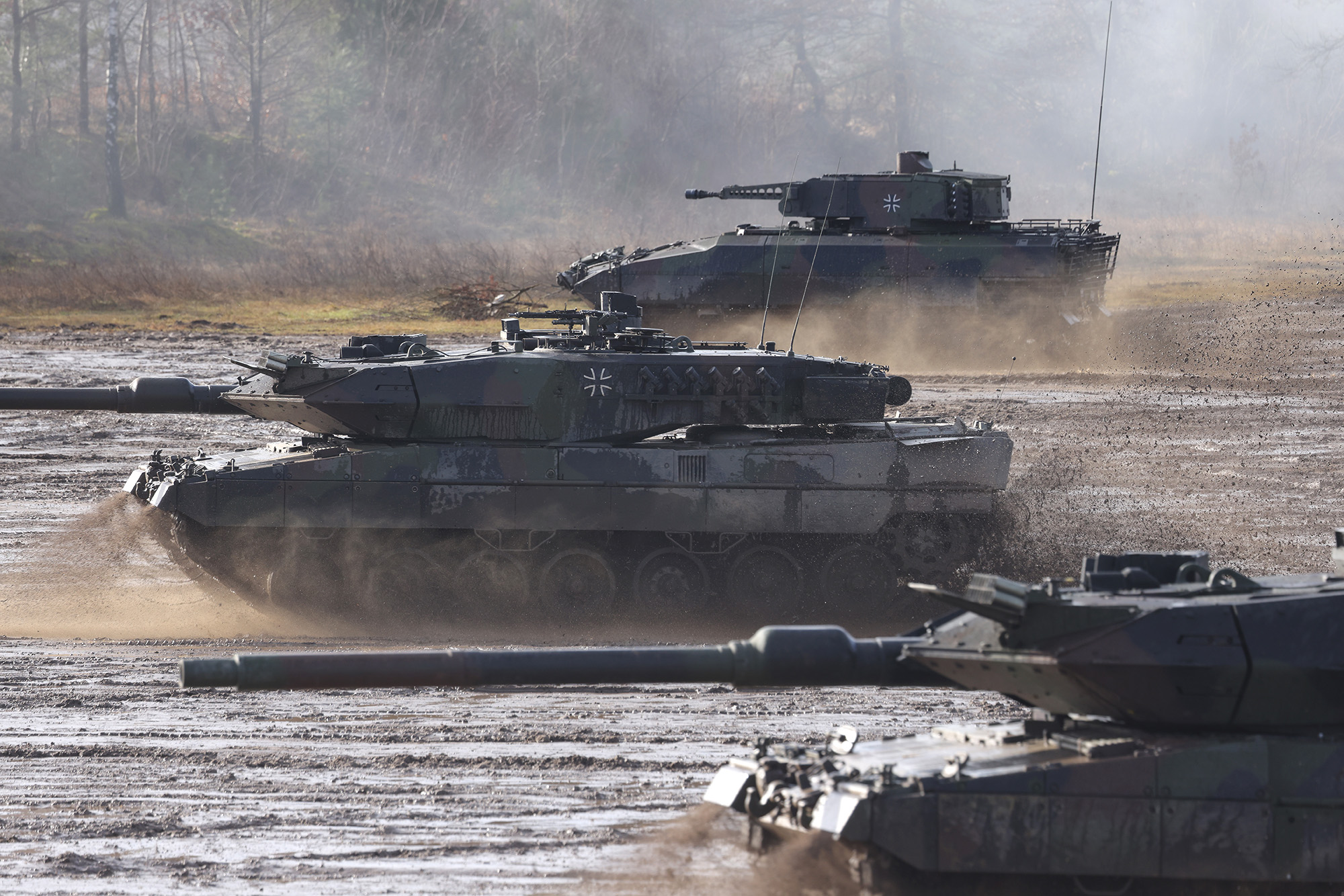 Two Leopard 2 A6 heavy battle tanks and a Puma infantry fighting vehicle of the Bundeswehr's 9th Panzer Training Brigade participate in a demonstration at the Bundeswehr Army training grounds on February 7, in Munster, Germany. 