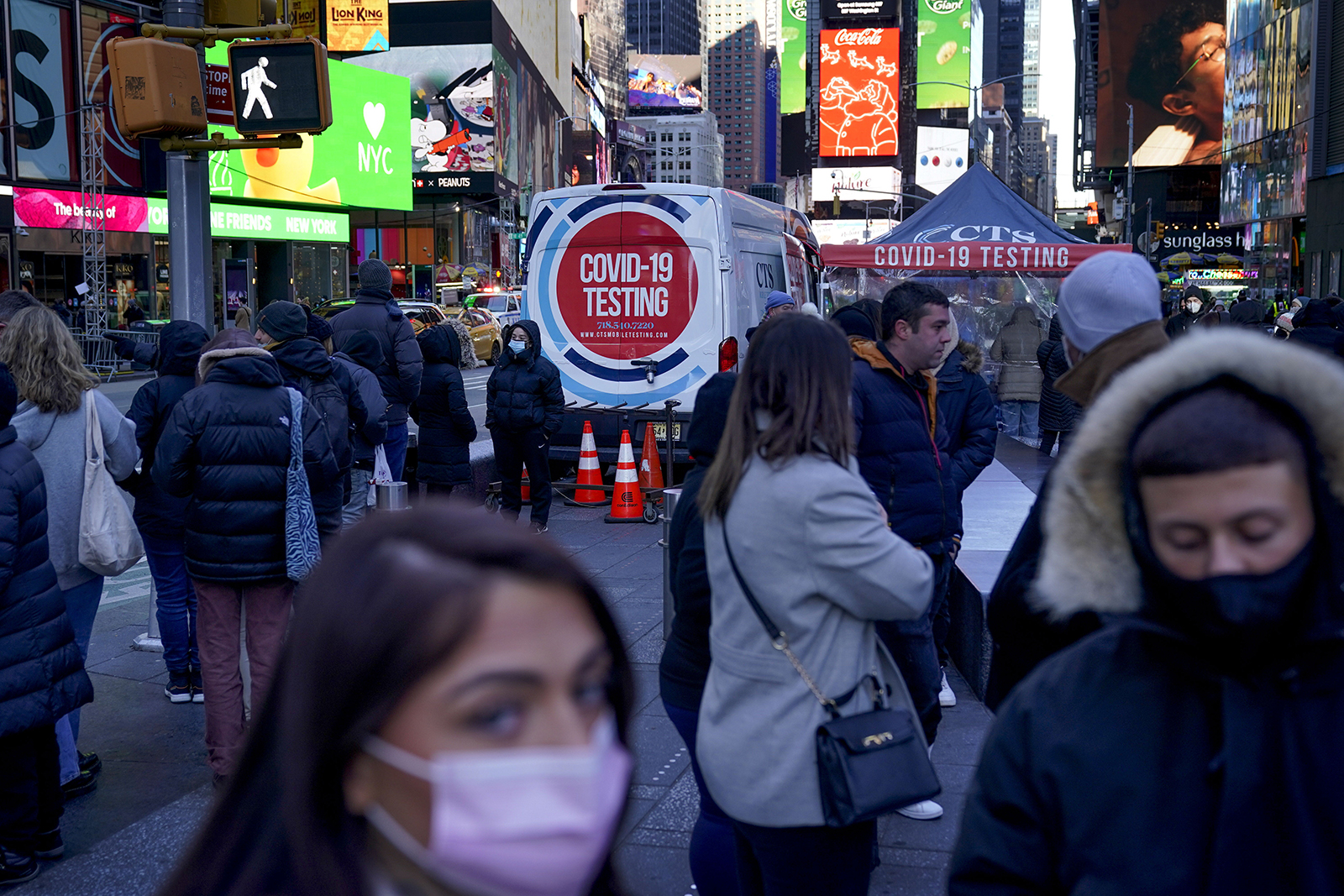 People wait in line to get tested for COVID-19 in Times Square, New York, on Dec. 20, 2021.