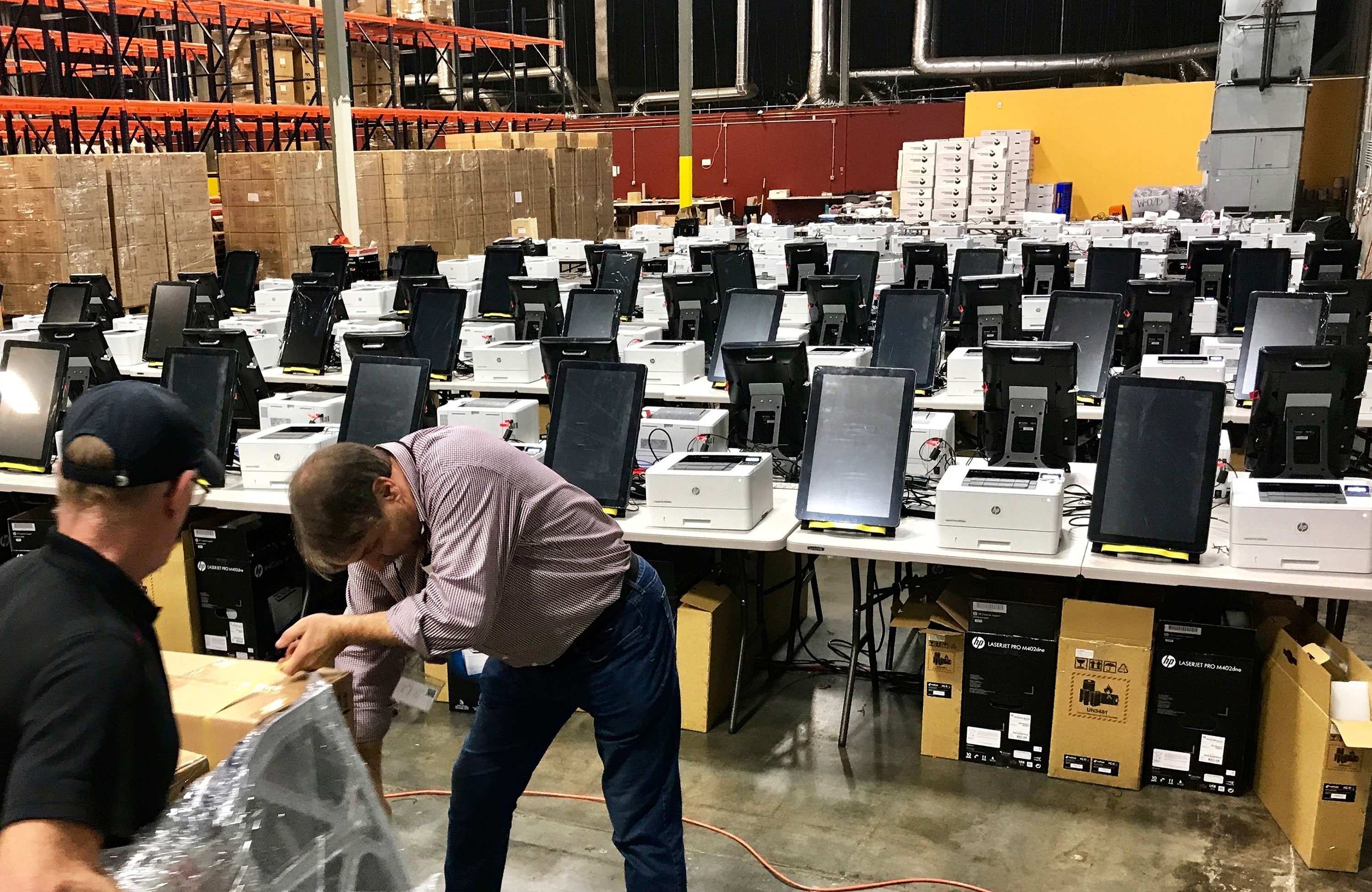 Voting equipment is prepared for testing in Atlanta on February 14 before being shipped to various counties throughout Georgia.