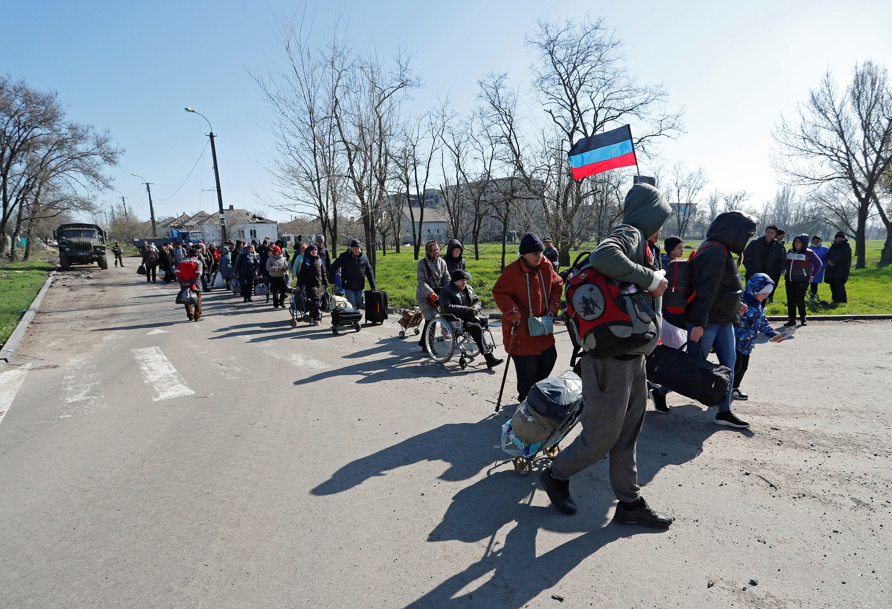 Evacuees walk toward buses to leave Mariupol, Ukraine, on April 20.