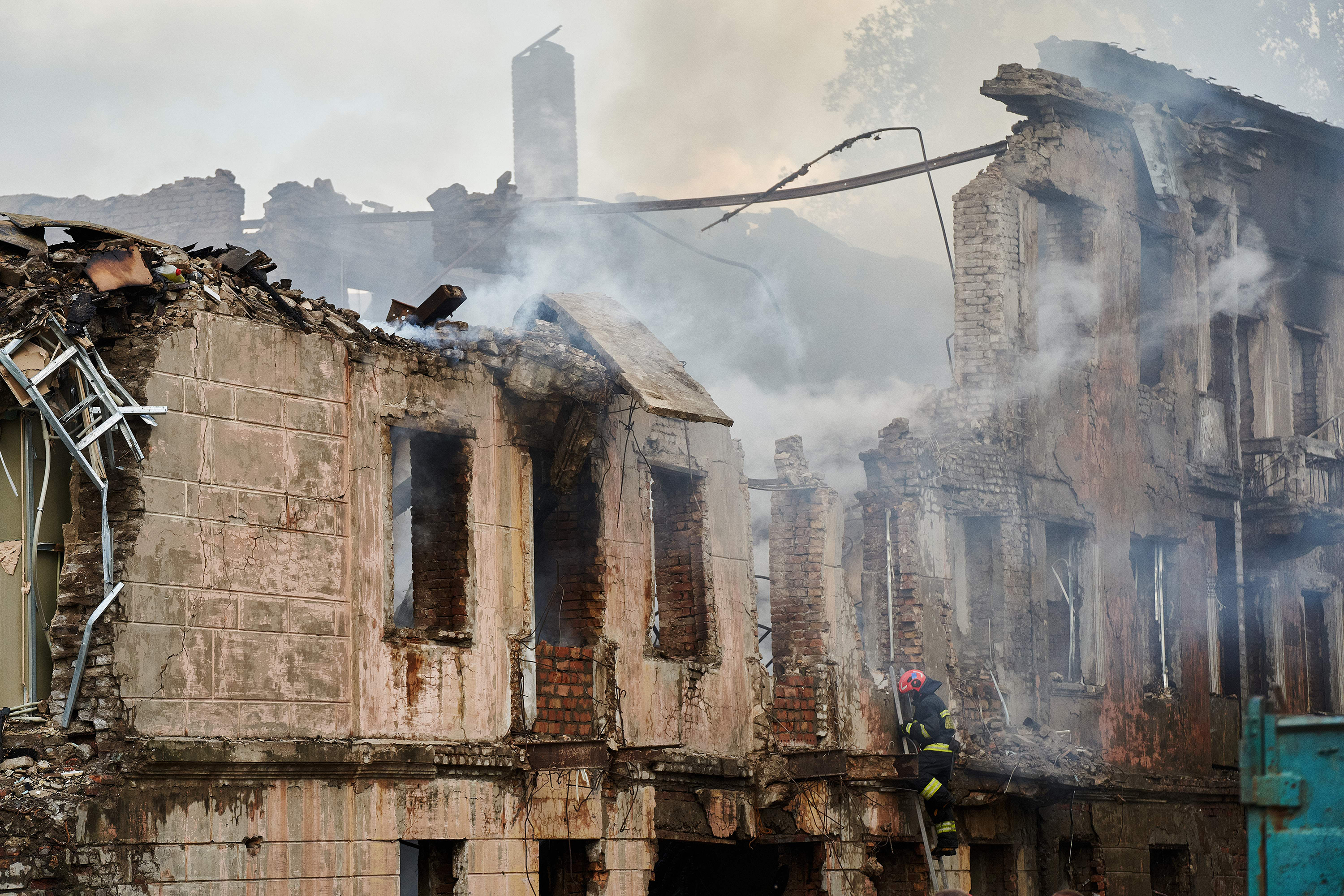 A firefighter examines the destroyed building of a medical facility, the site of a missile strike, in the city of Dnipro on May 26.
