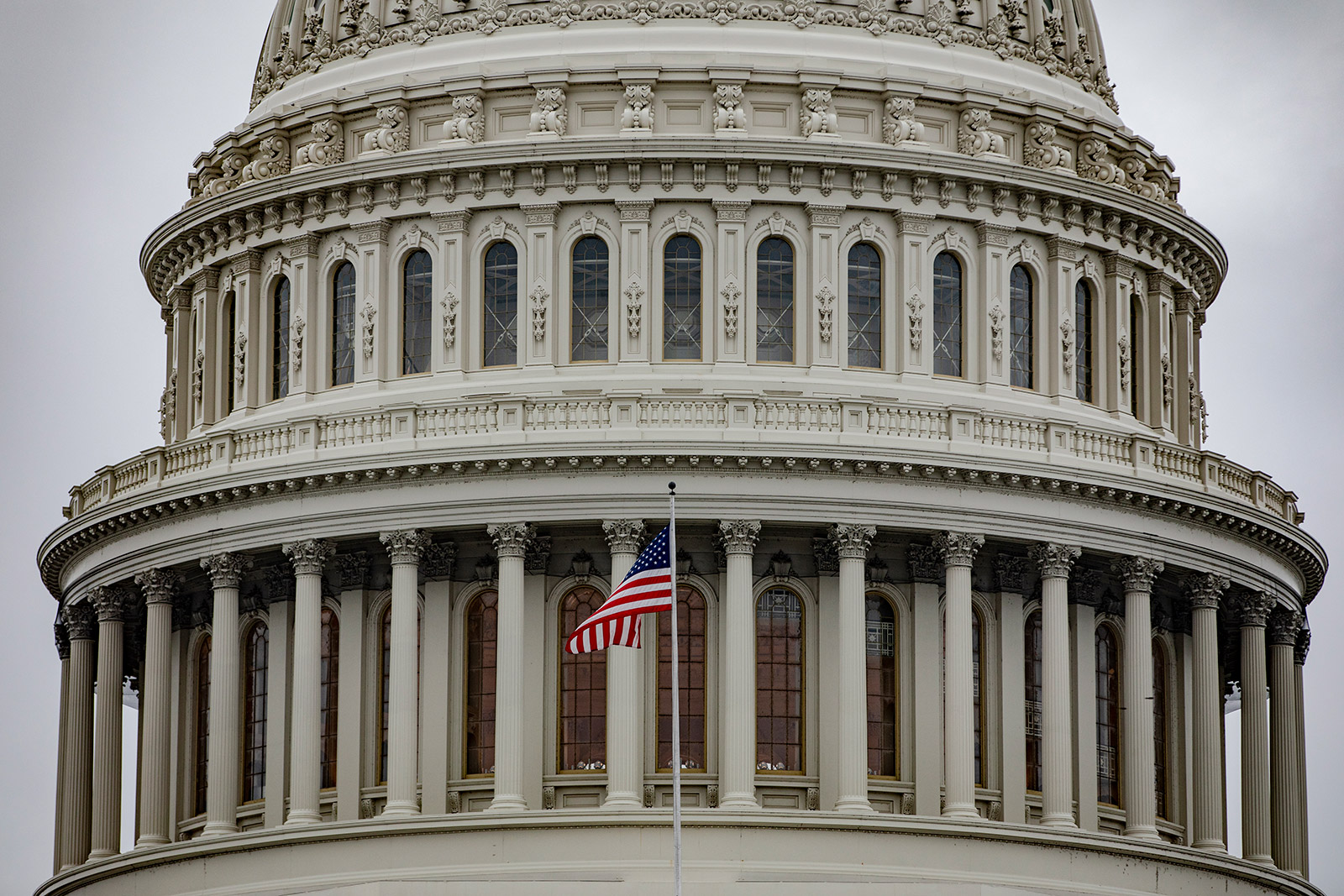 An American flag flies in front of the Capitol building in Washington, DC.