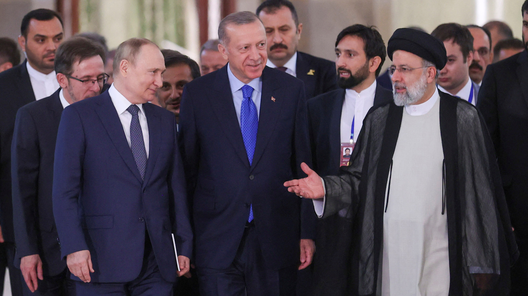 Russian President Vladimir Putin, Turkish President Tayyip Erdogan and Iranian President Ebrahim Raisi arrive at a news conference in Tehran, Iran on Tuesday.