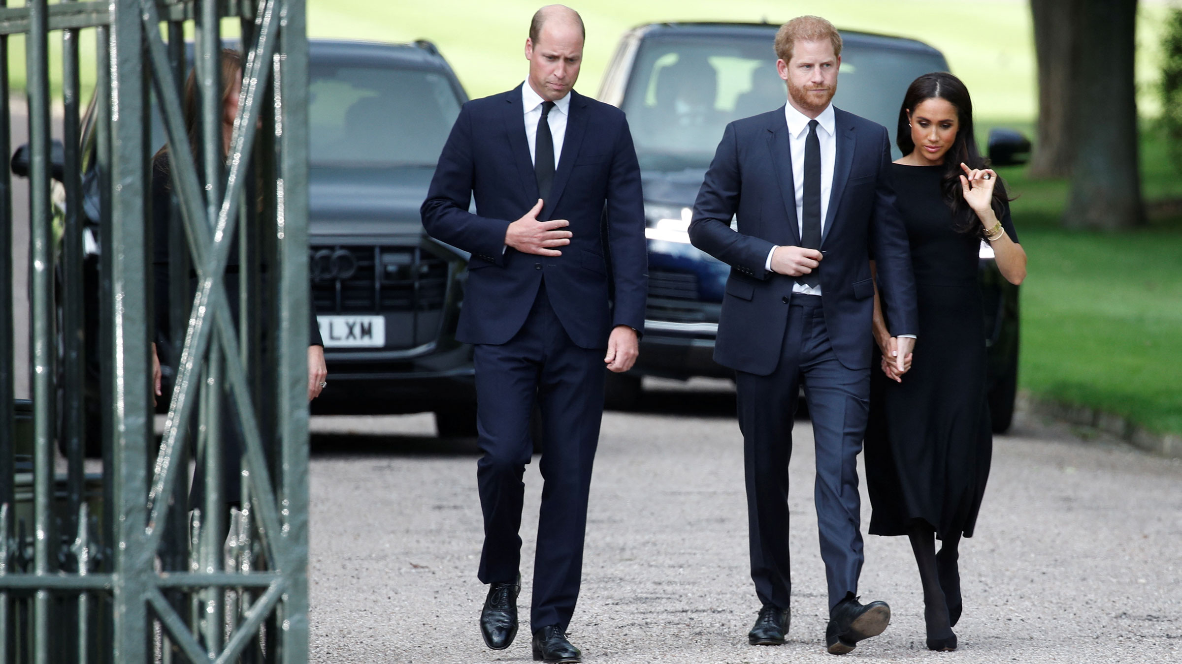 Prince William walks with his brother, Prince Harry, and Meghan, the Duchess of Sussex, on Saturday.