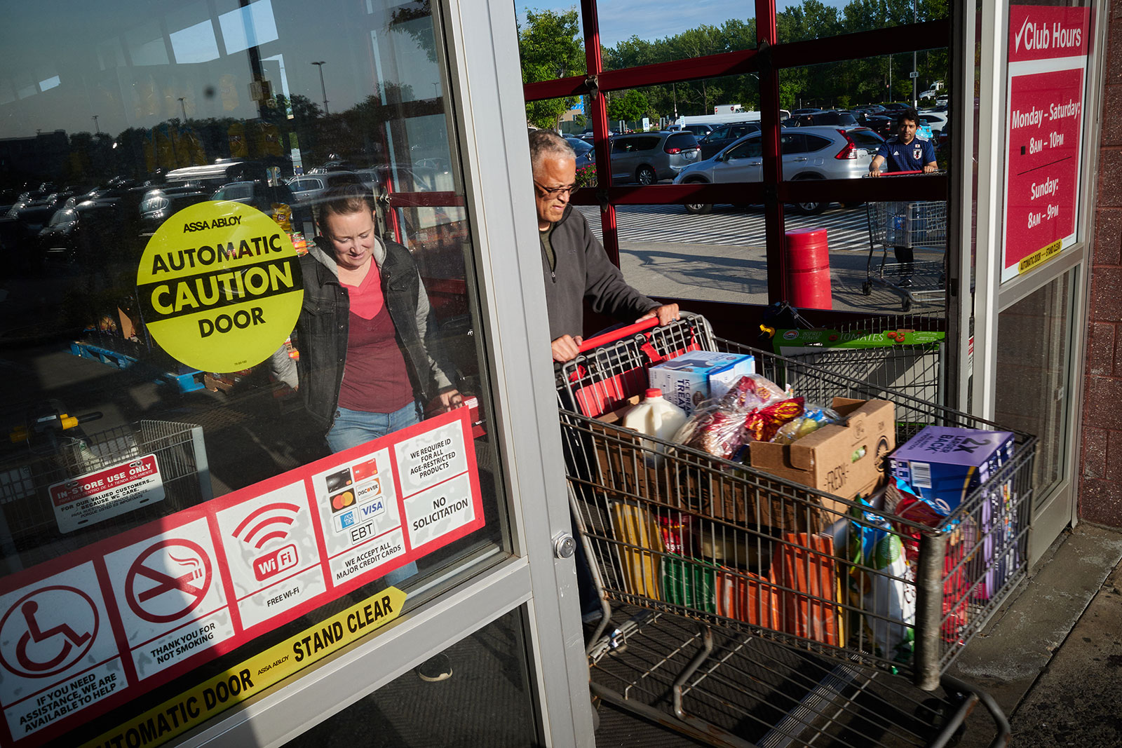 Shoppers exit a store in the Queens borough of New York, on May 19, 2023.