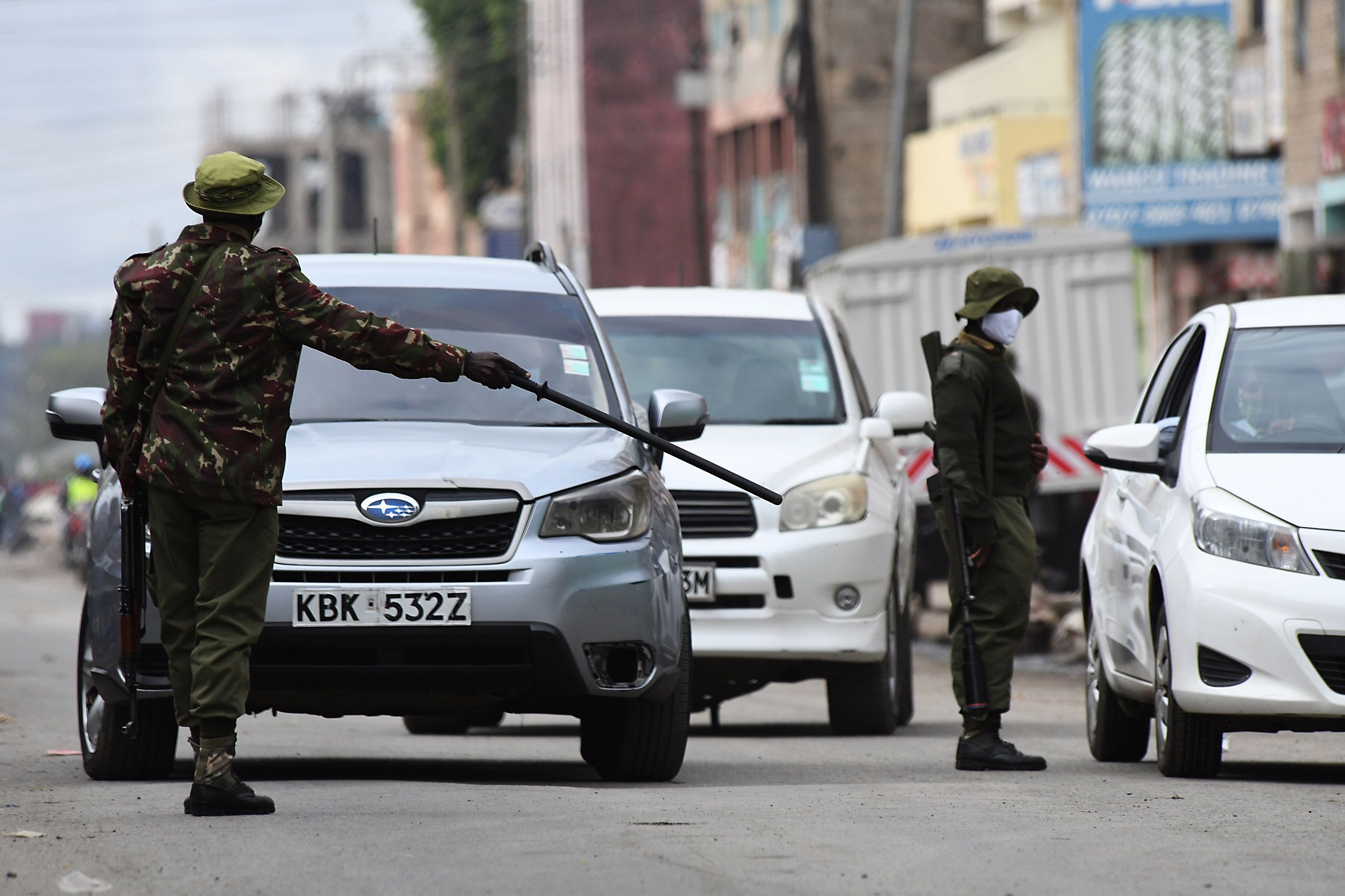 Kenyan police officers inspects drivers at a checkpoint following a partial lockdown in two COVID-19 hotspots of Eastleigh in Nairobi and Mombasa City in Kenya, on May 7. 