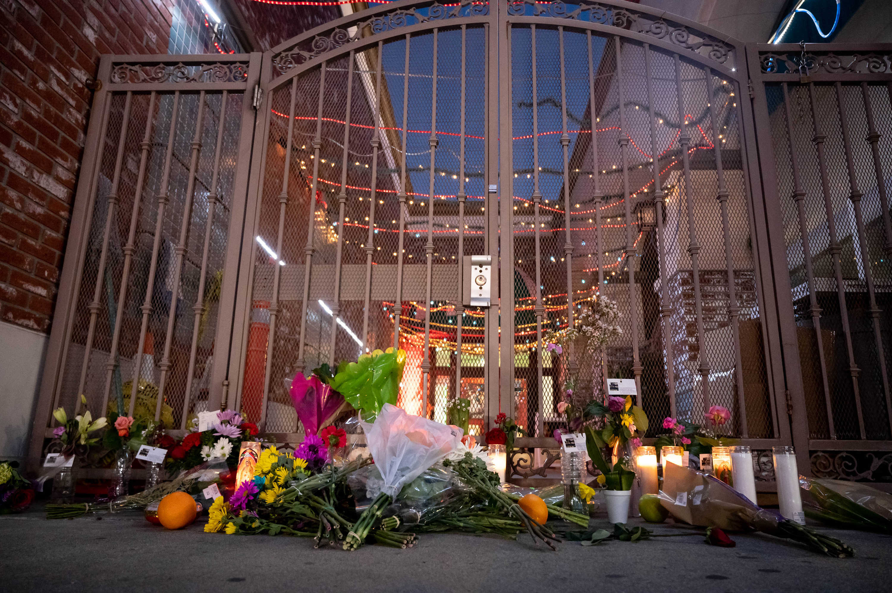 People leave flowers and candles at the Star Dance Studio in Monterey Park, California for the victims of the mass shooting on Monday.