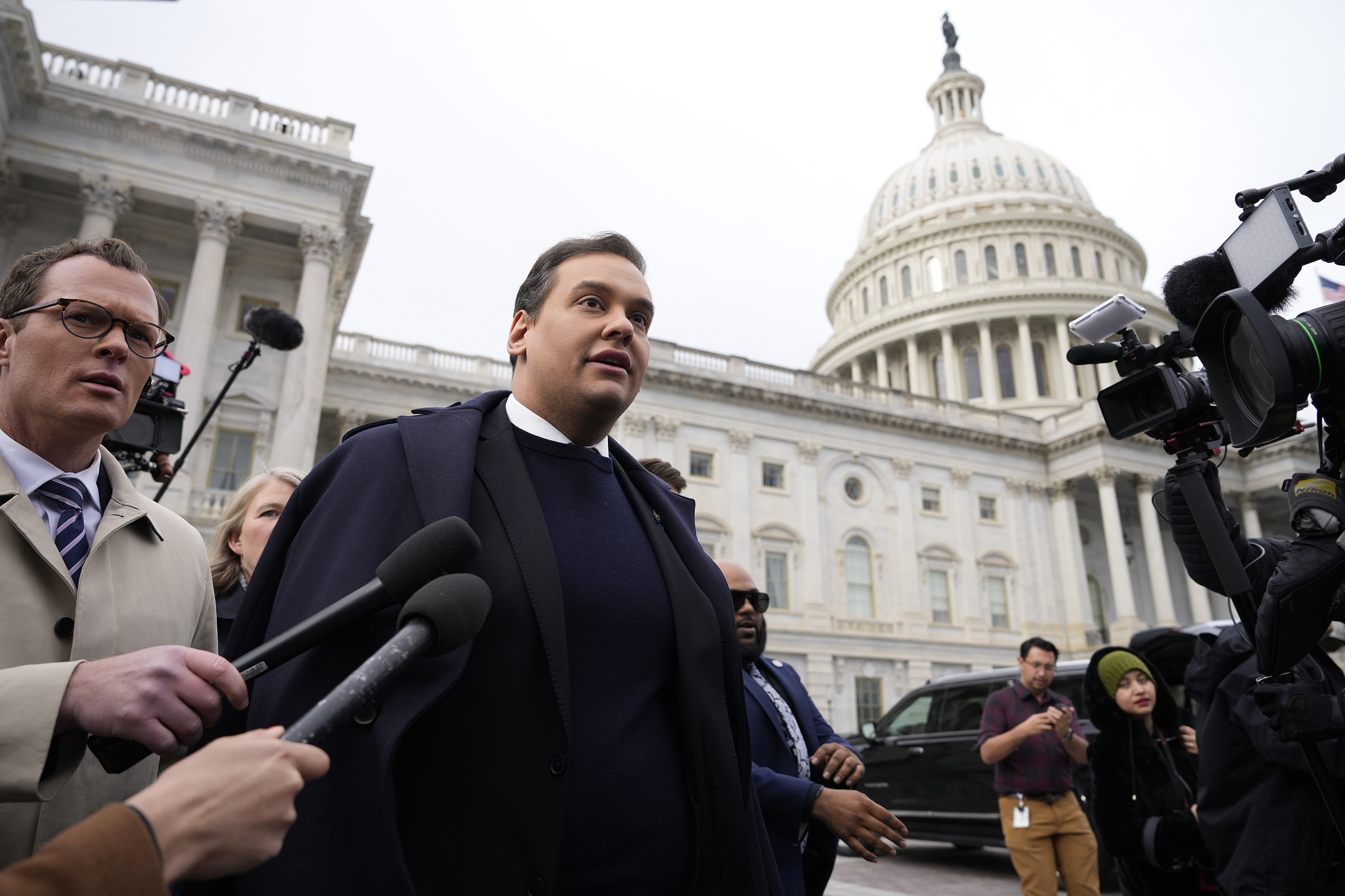 Rep. George Santos is surrounded by journalists as he leaves the U.S. Capitol after his fellow members of Congress voted to expel him from the House of Representatives on December 1, in Washington, DC.
