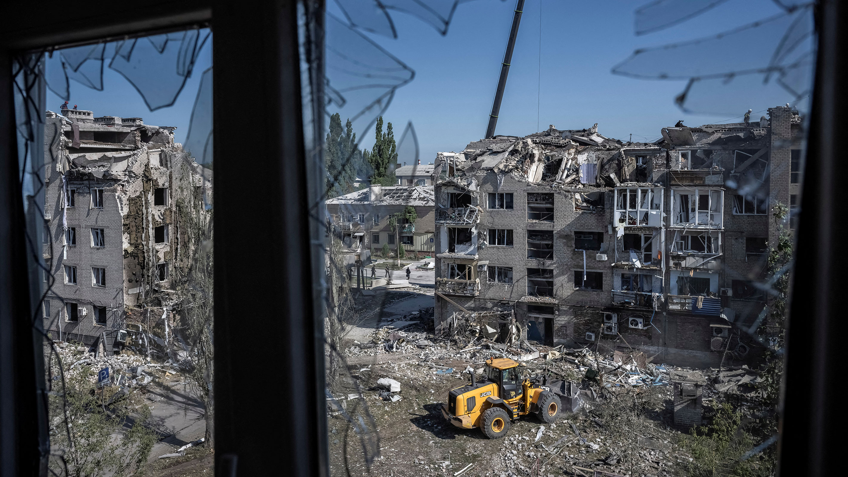 Rescuers work with heavy machinery, at the site of a building destroyed during a Russian missile strike in Pokrovsk in the Donetsk region of Ukraine on August 8.