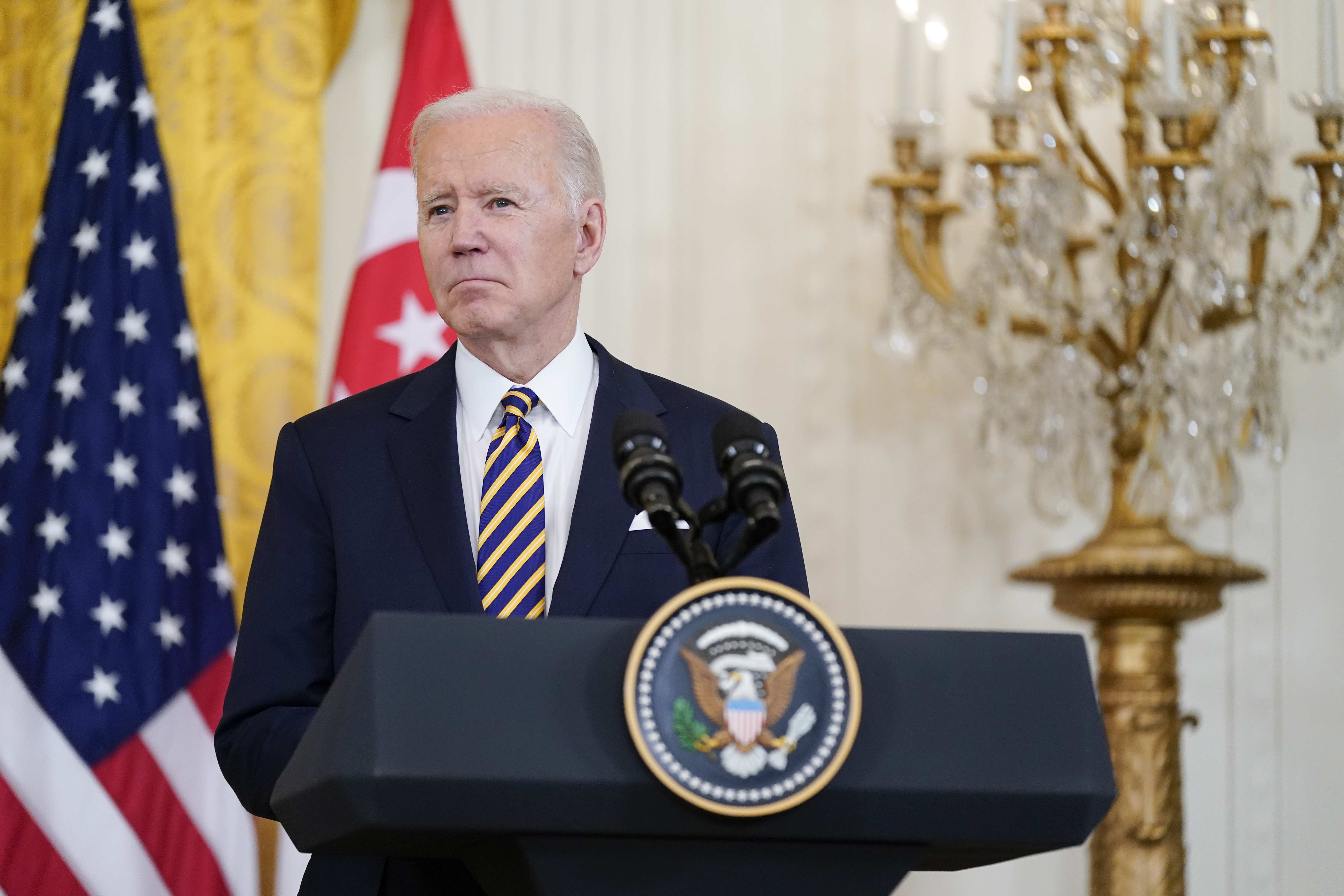 US President Joe Biden listens to a reporter's question in the East Room of the White House, on March 29, in Washington. 