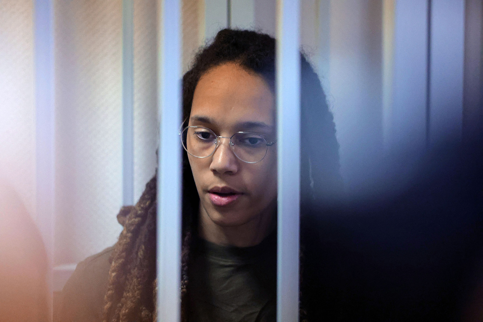 US basketball player Brittney Griner stands in a defendants' cage before a court hearing during her trial on charges of drug smuggling, in Khimki, outside Moscow, Russia, on August 2.
