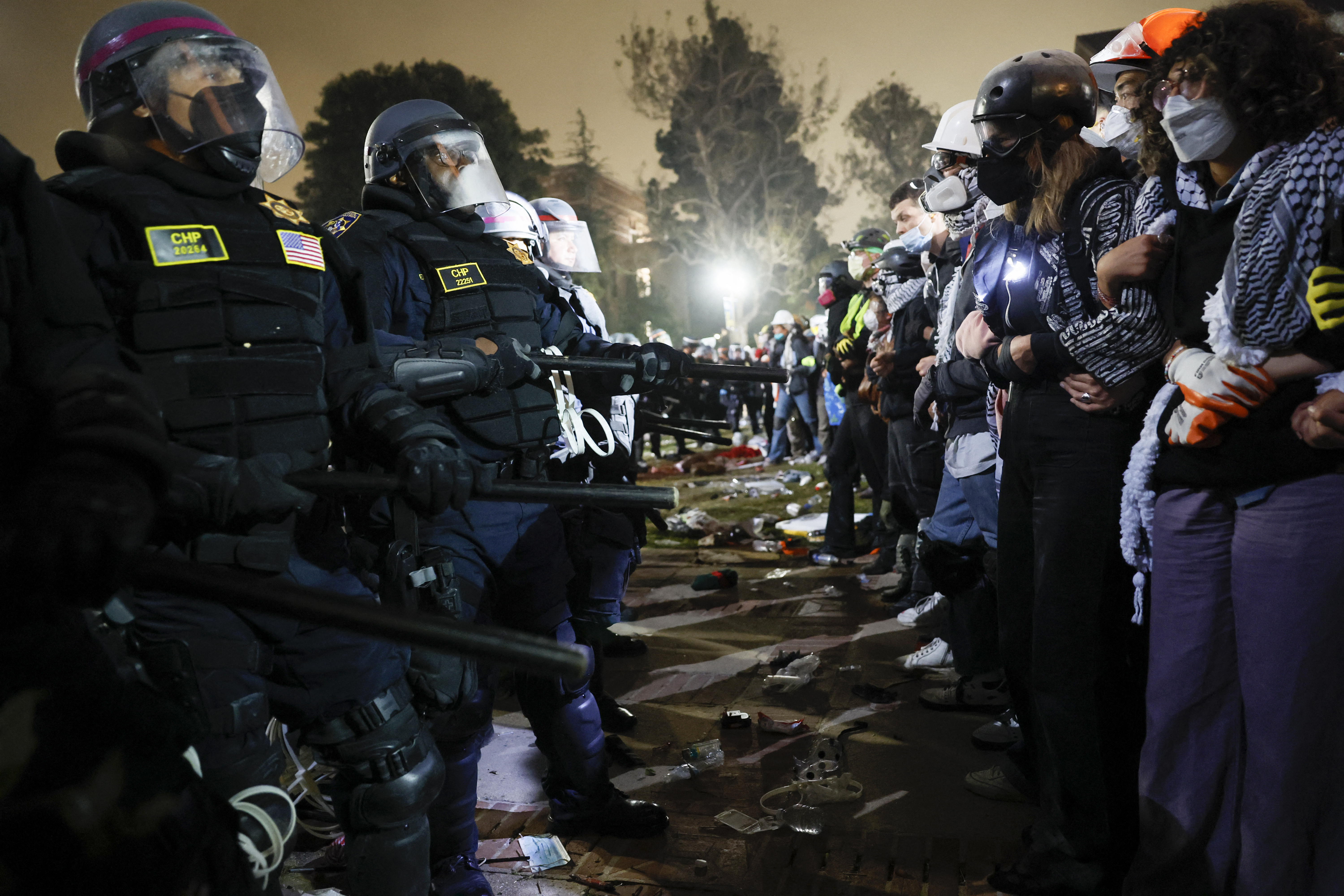Police face off with pro-Palestinian protesters after destroying part of the encampment barricade on the UCLA campus early on Thursday, May 2.