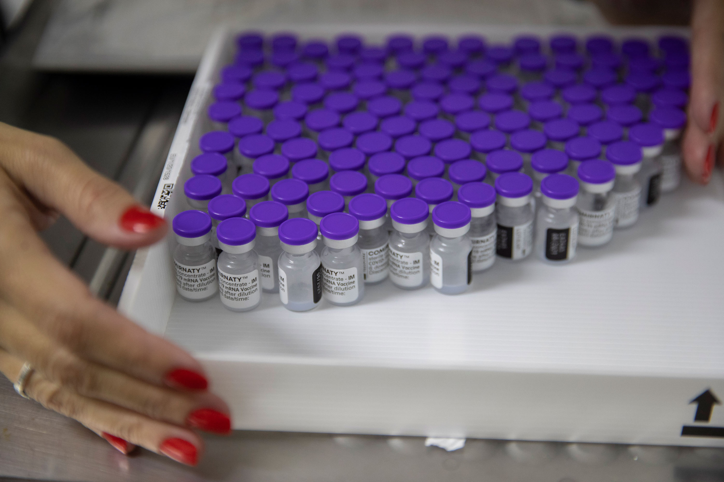 A health worker holds a tray with vials of the Pfizer vaccine for COVID-19 at a community medical center in Sao Paulo, Brazil, on May 6.