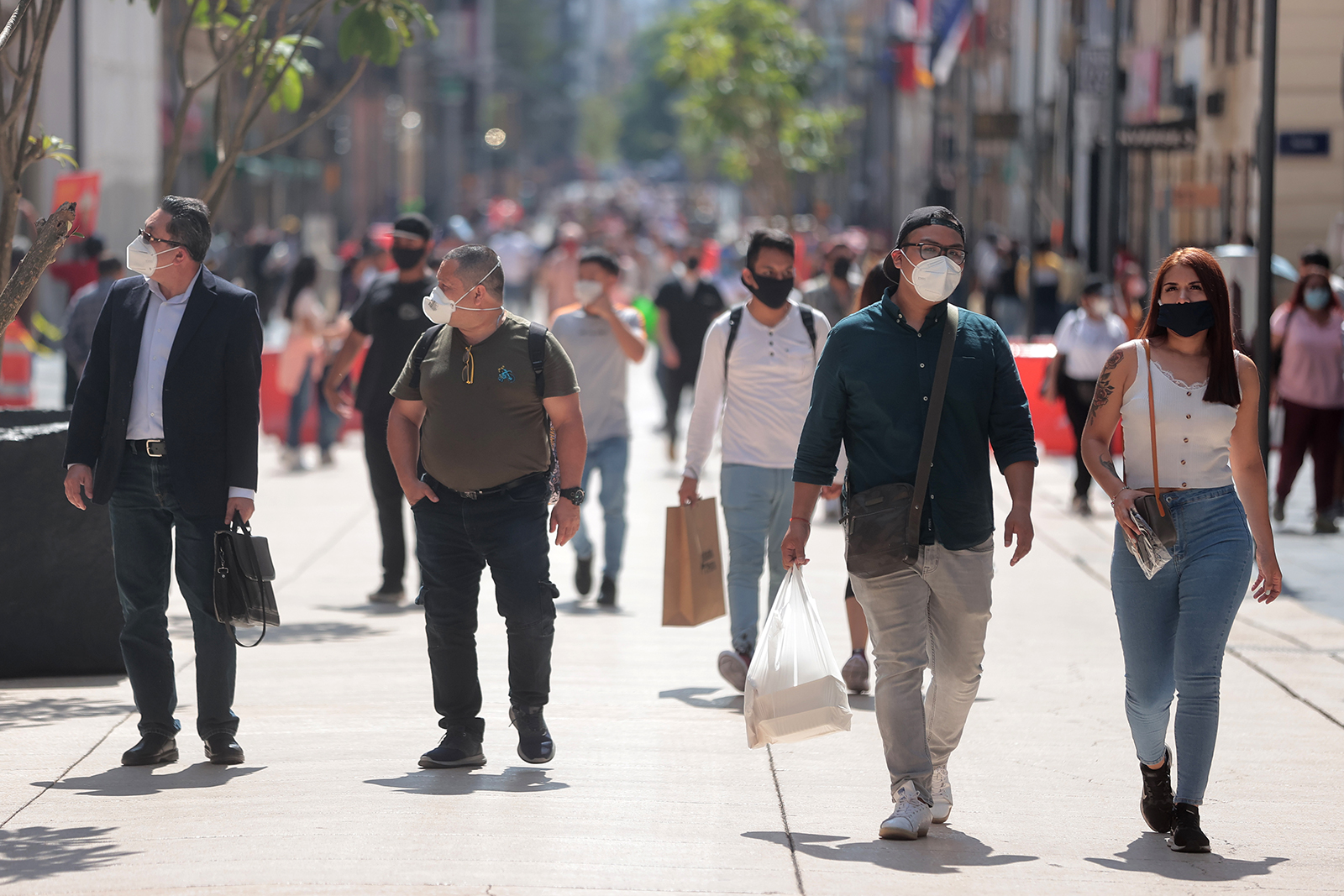Streets in downtown Mexico City are full of people using face masks on July 13.
