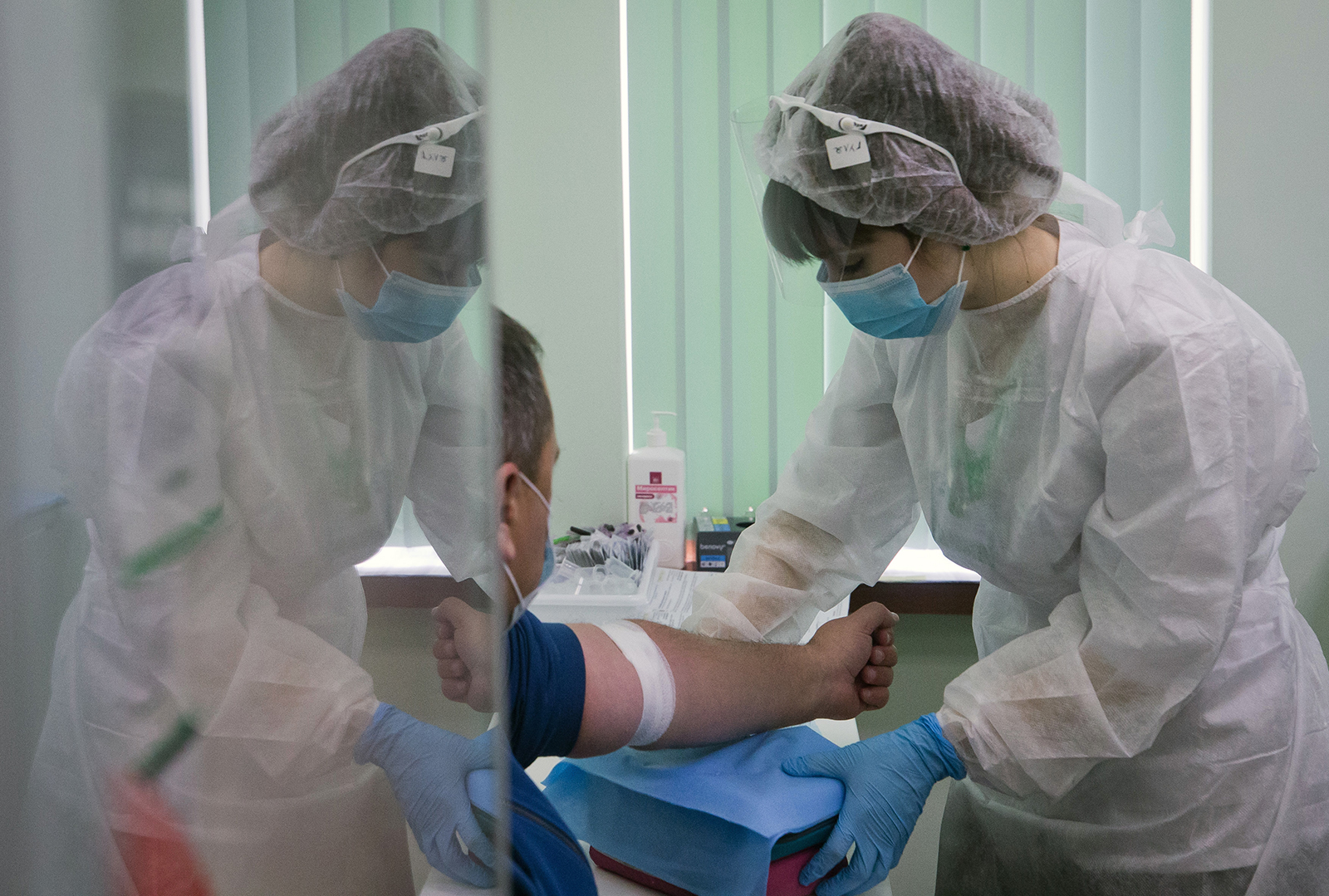 A medical worker takes a venous blood sample from a patient for Covid-19 antibody testing at a Gemotest lab in Simferopol, Crimea, Russia, on November 20.