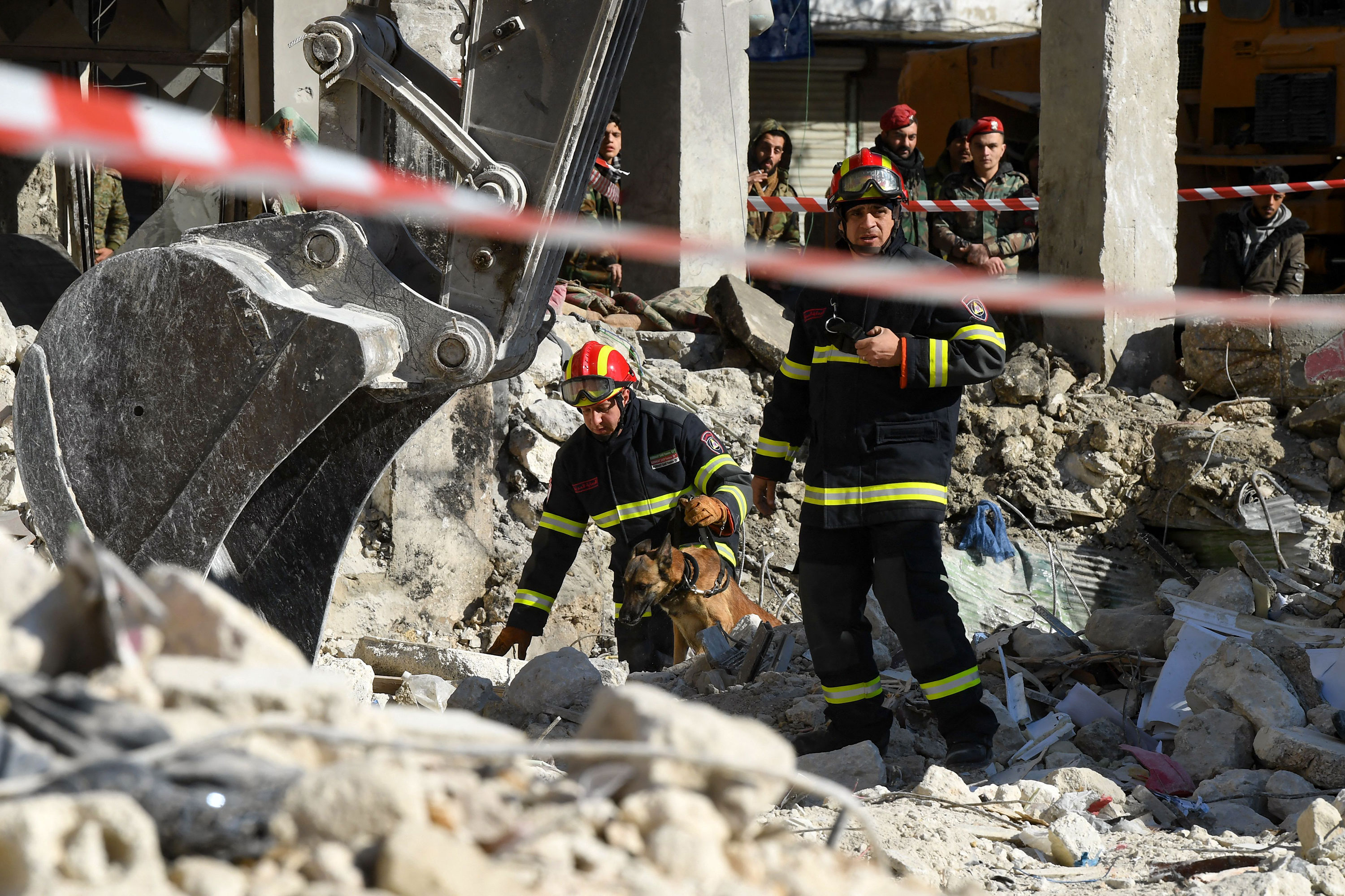 Algerian rescue teams use a dog as they search the rubble in Aleppo on Wednesday.