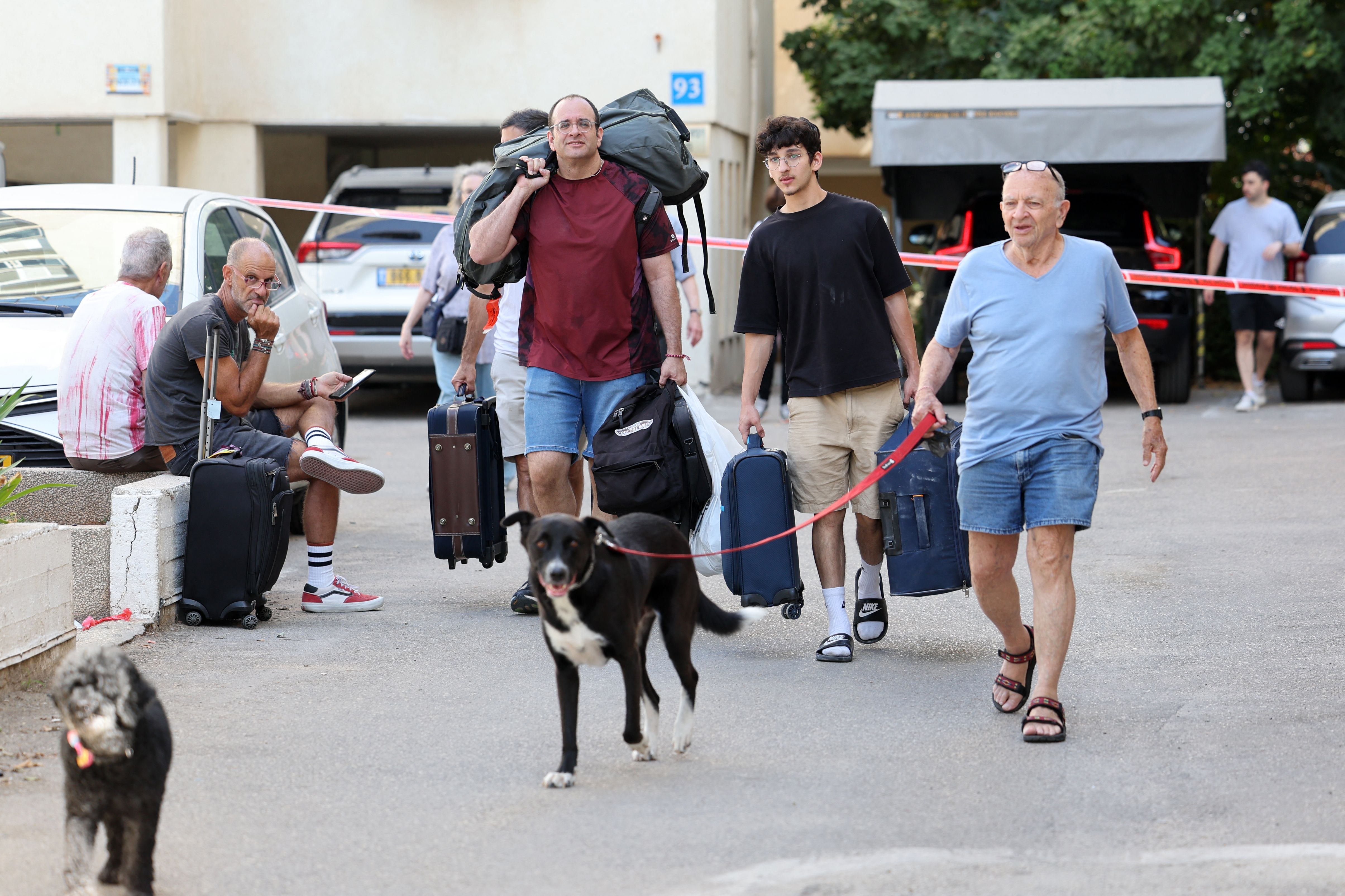 Residents leave their homes in Tel Aviv on October 7, 2023, after a barrage of rockets were fired from the Gaza Strip into Israel.