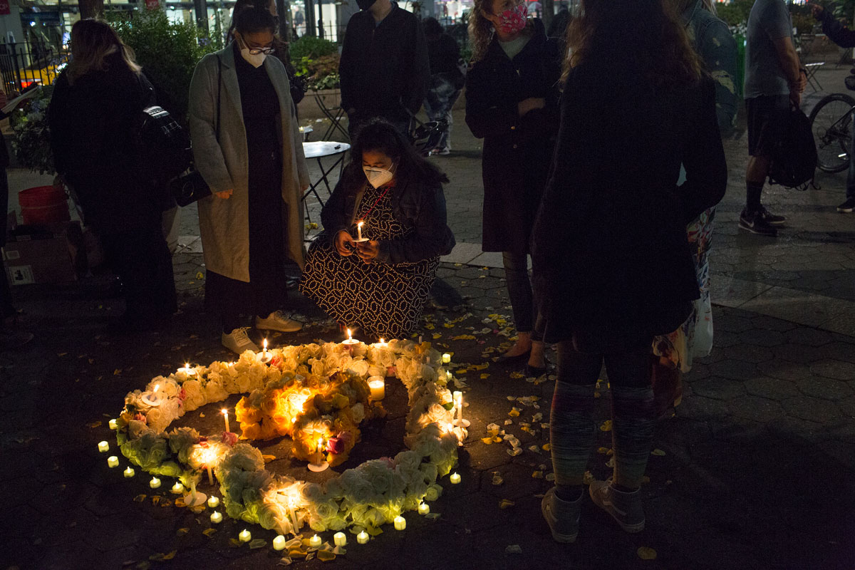 The group Marked by COVID holds a vigil and listens to the stories of people who have lost close relatives from the COVID-19 pandemic in a public memorial for the dead on October 8 in Greely Square, New York.