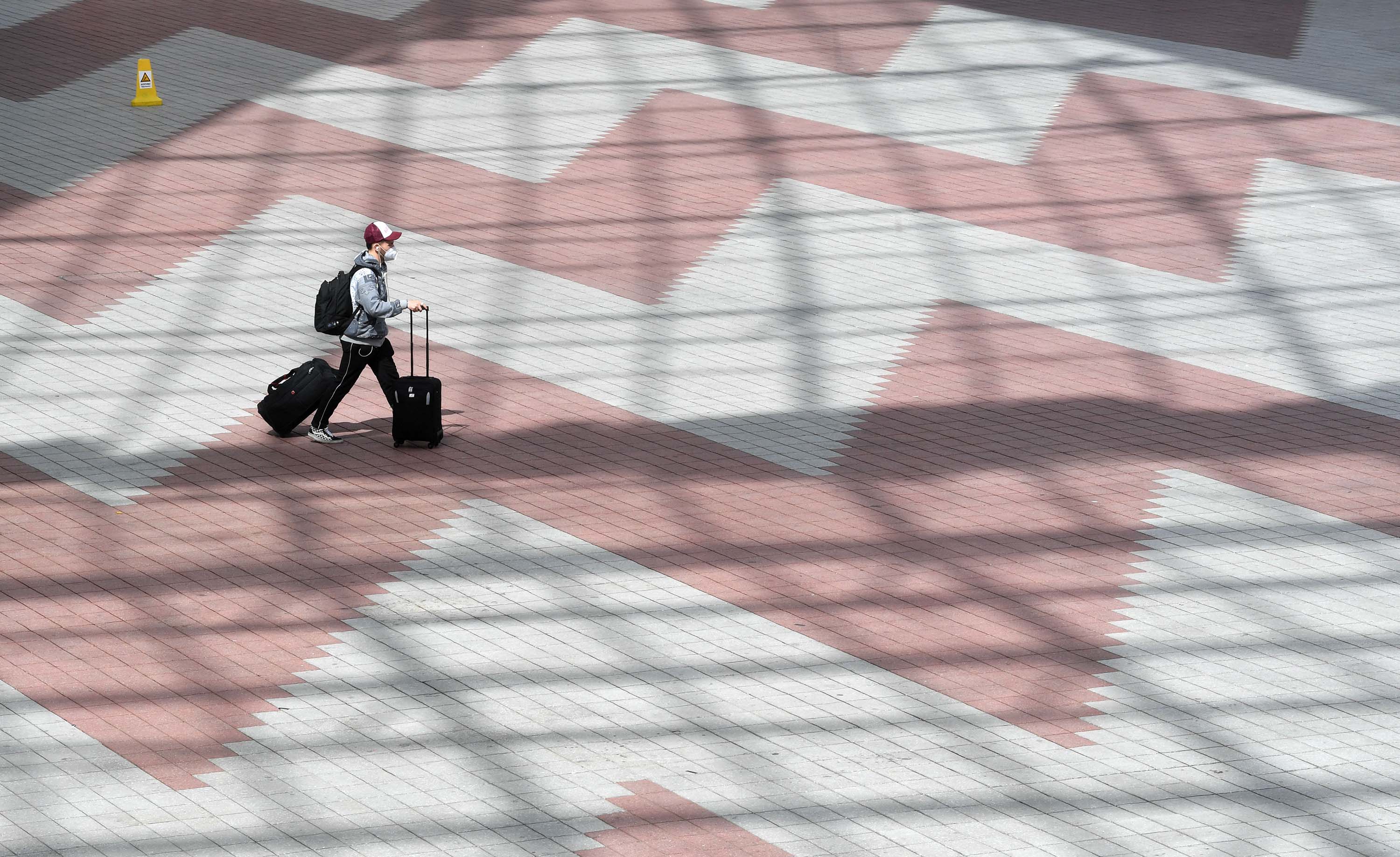 A passenger walks between terminals of the Franz-Josef-Strauss airport in Munich, Germany, on April 8. 