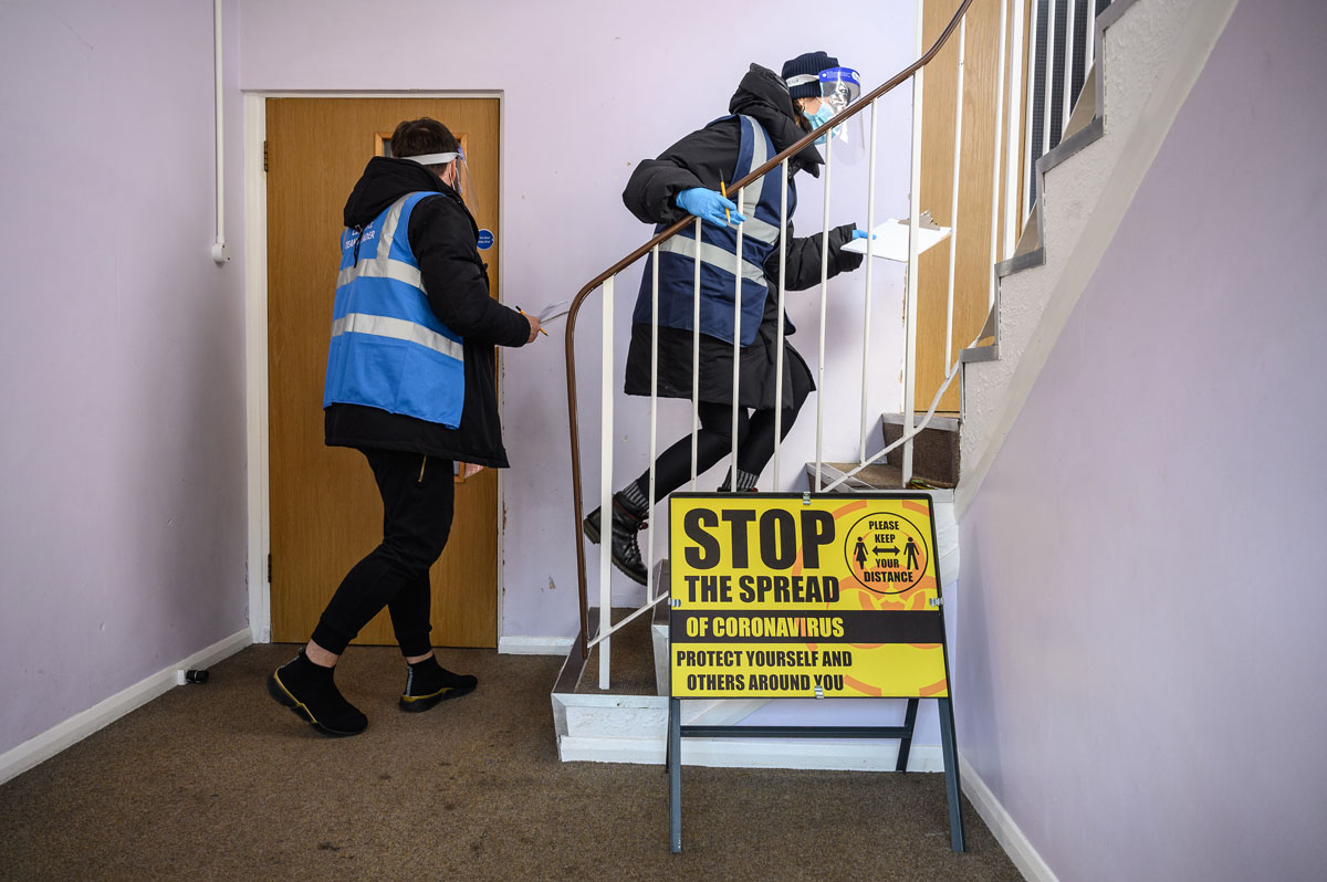 Volunteers deliver Covid-19 test kits to the doors of residents near Muswell Hill on March 22 in London, England.