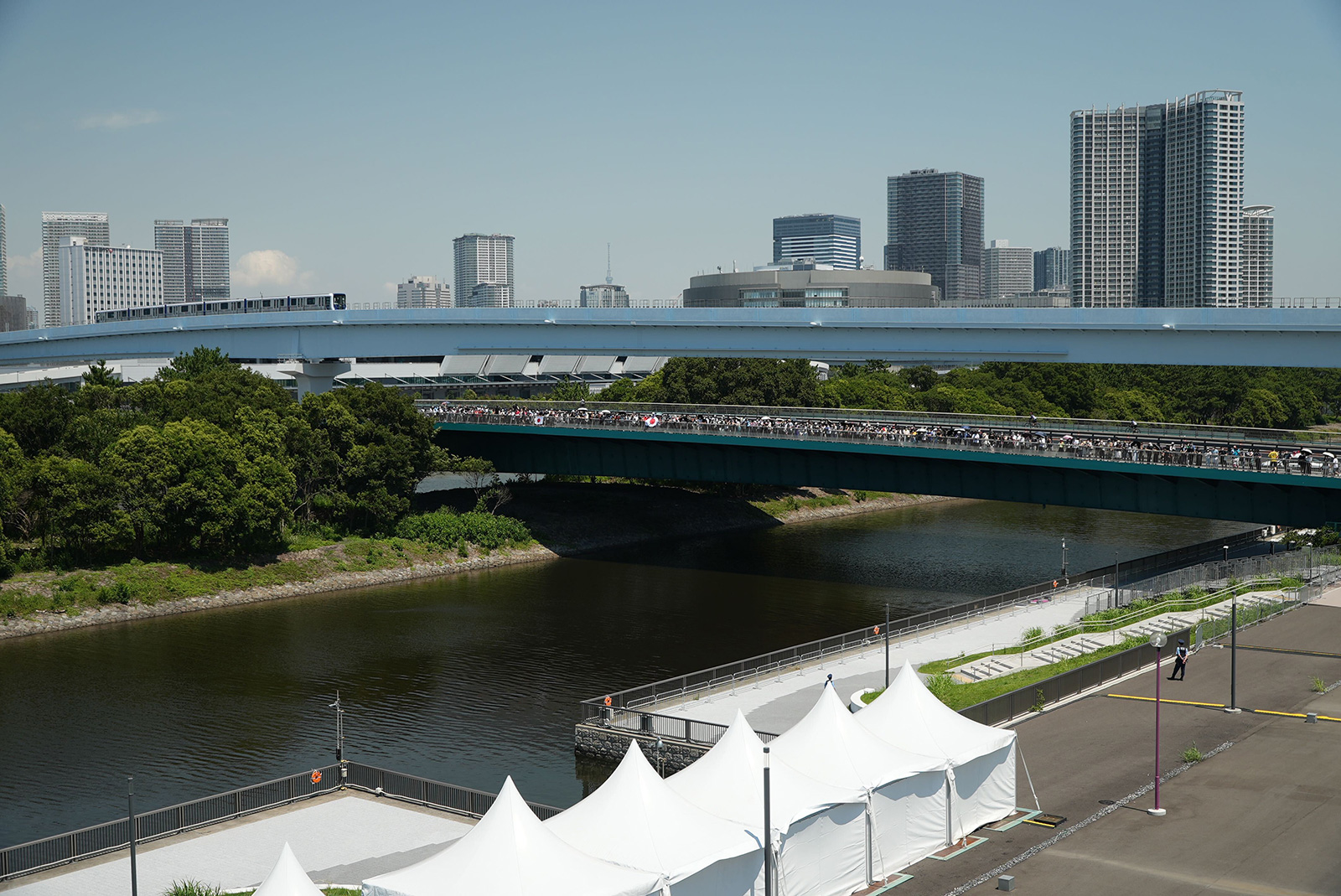 People watch the BMX freestyle event from a bridge in Tokyo on Sunday.