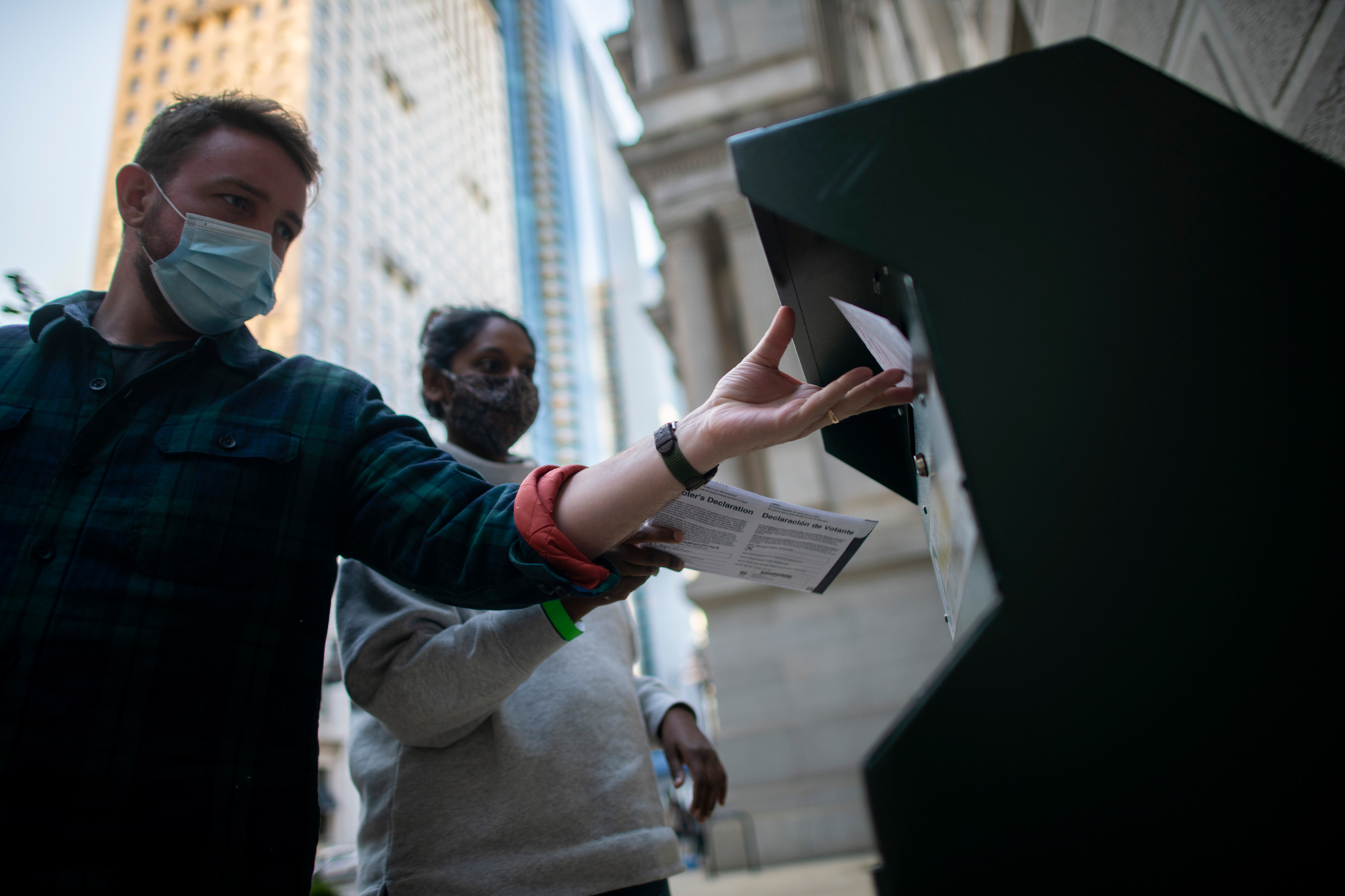 Voters cast their early voting ballot at drop box outside of City Hall on October 17 in Philadelphia, Pennsylvania. 