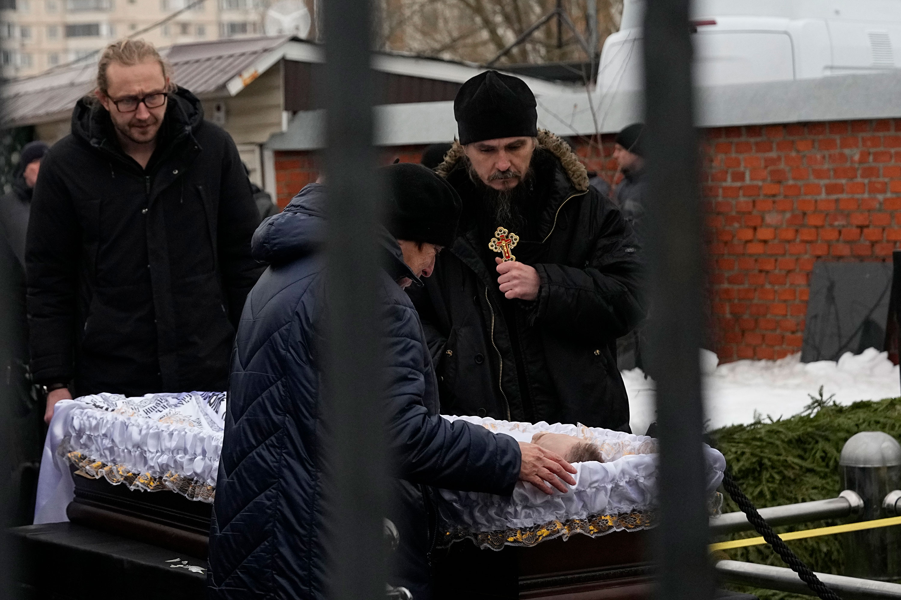 People pay their last respects as the open casket Alexey Navalny is placed next to the burial site at the Borisovsky cemetery in Moscow on Friday.