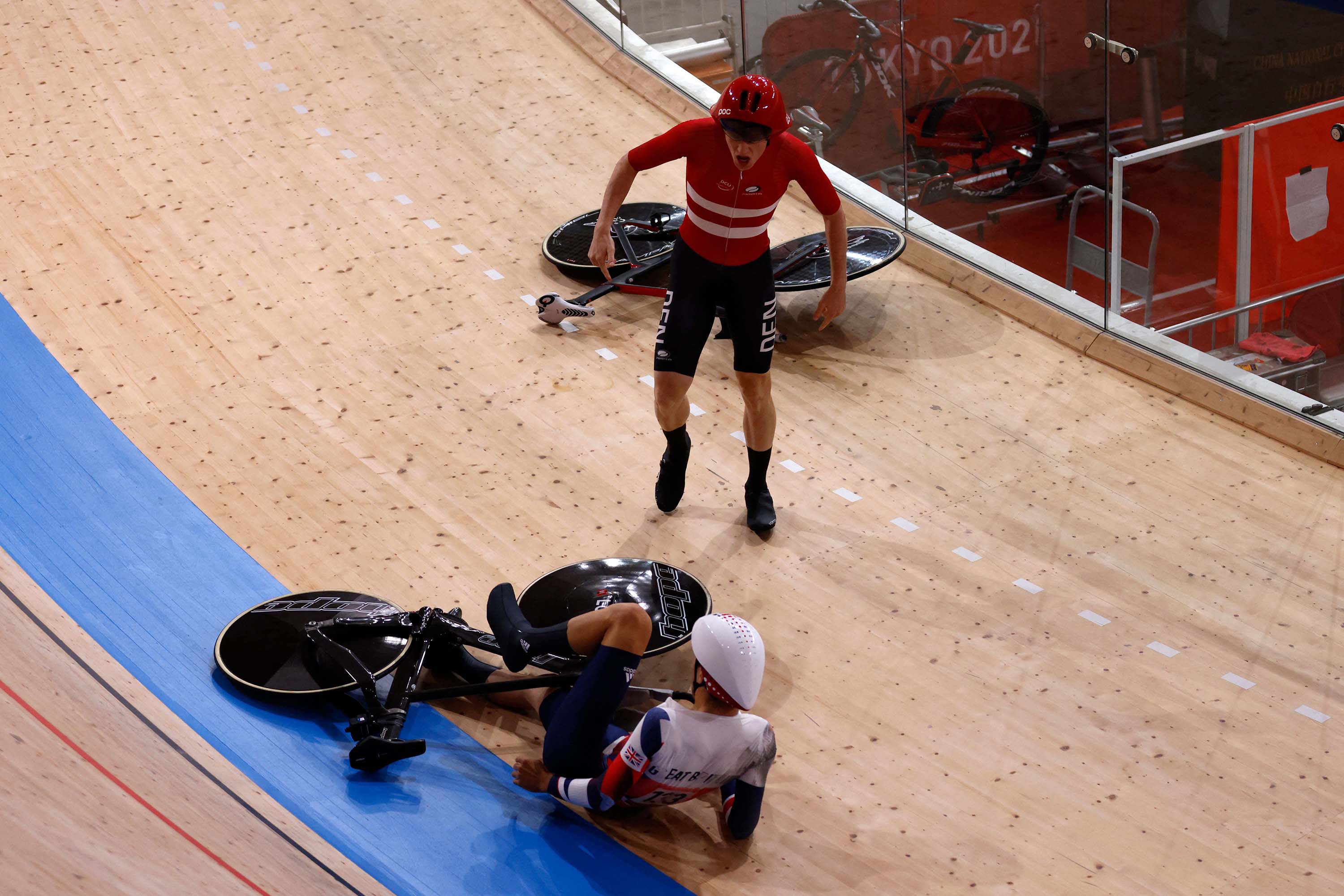 Denmark's Frederik Madsen reacts after a crash with Great Britain's Charlie Tanfiled, bottom, during the first round heats of the men's track cycling team pursuit on August 3. 