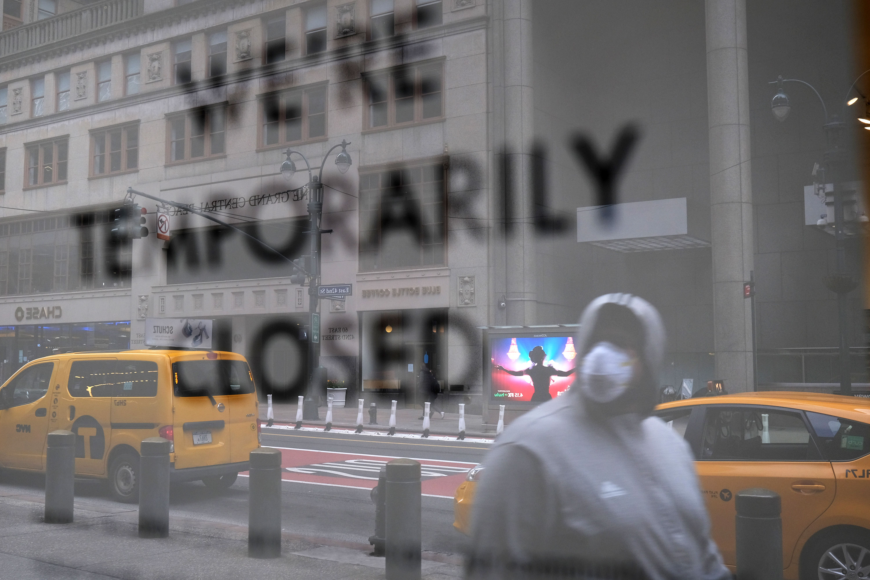 A pedestrian walks past a closed business, in Manhattan, New York, on April 10.