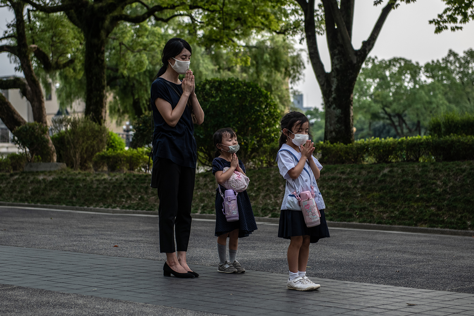 A mother and her daughters pray at the Students Peace Monument on the 75th anniversary of the Hiroshima atomic bombing, on August 6, in Hiroshima, Japan. 