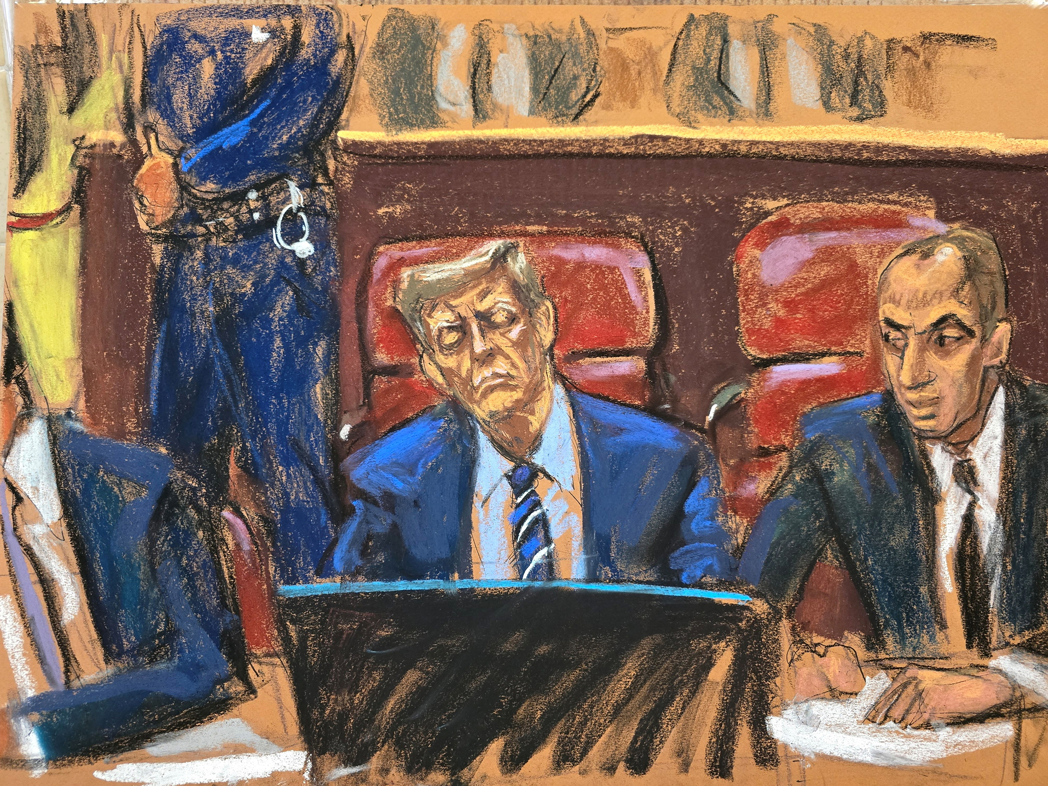 Former President Donald Trump sits at the defense table beside his lawyer Emil Bove.