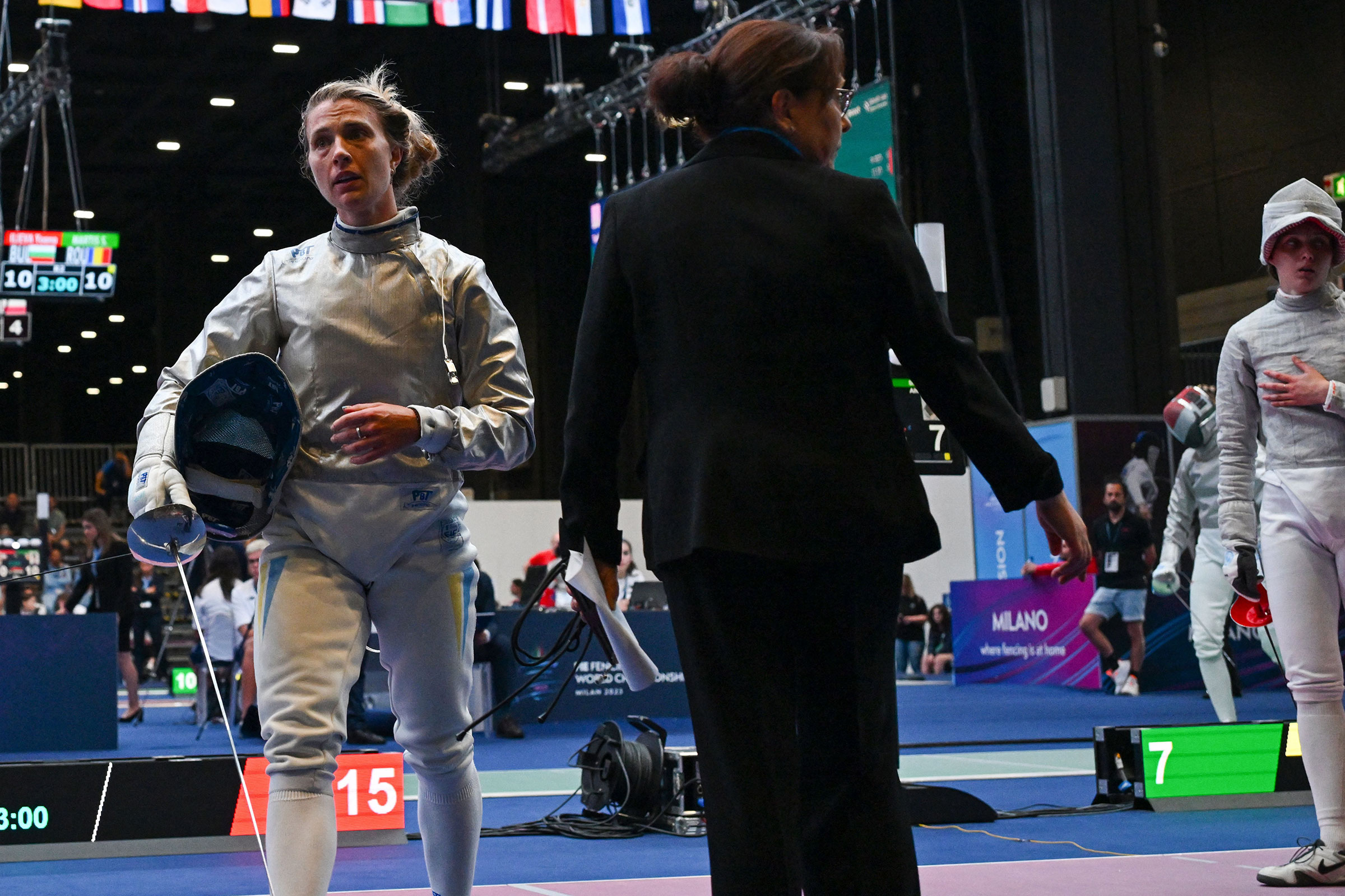Ukraine's Olga Kharlan leaves the fencing strip after she refused to shake hands with Russia's Anna Smirnova, registered as an Individual Neutral Athlete (AIN), after Kharlan defeated Smirnova during the Sabre Women's Senior Individual qualifiers, as part of the FIE Fencing World Championships at the Fair Allianz MI.CO (Milano Convegni) in Milan, on July 27, 2023.