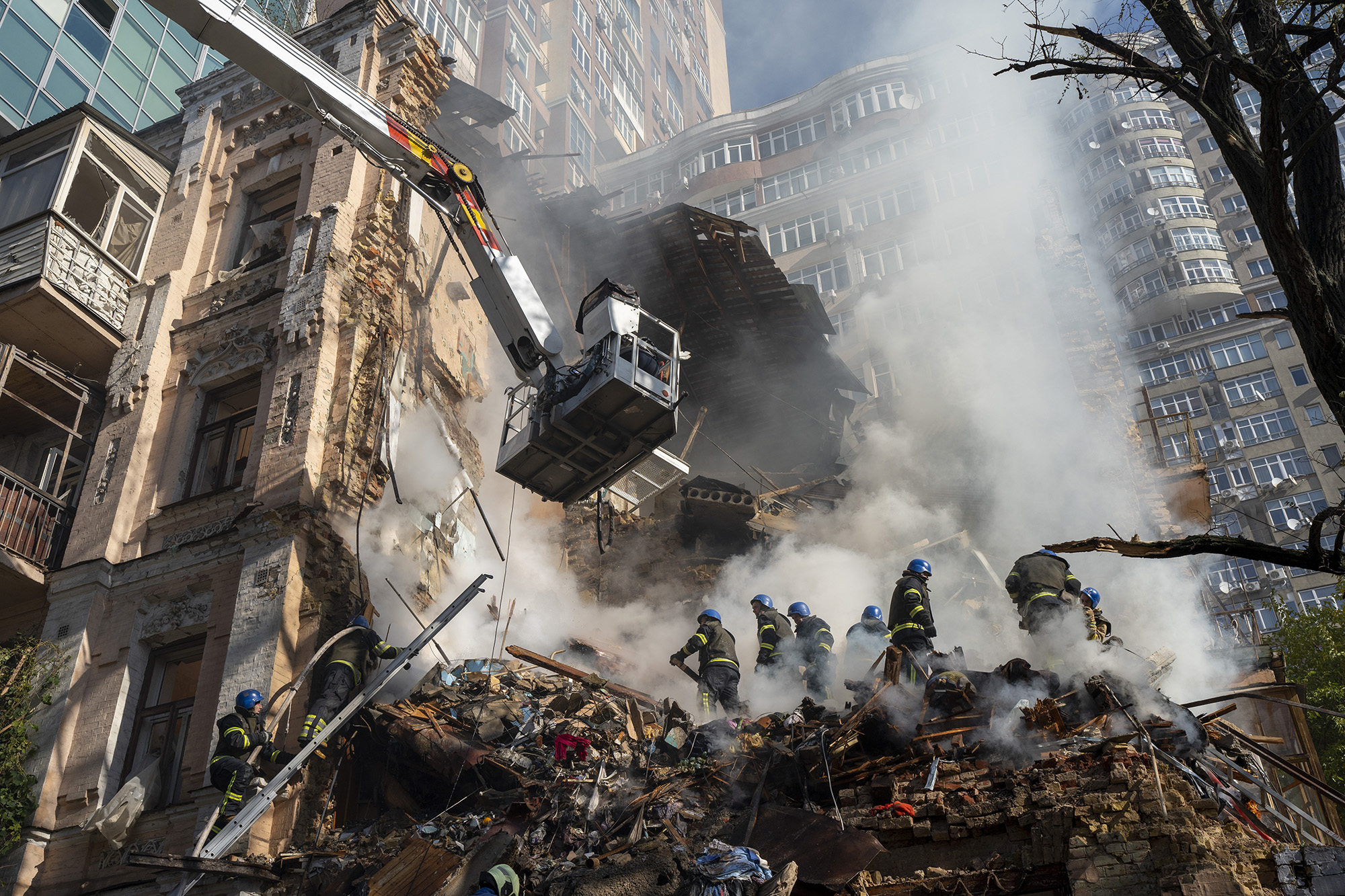 Firefighters work on a building in Kyiv, Ukraine, on October 17, after a Russian drone attack.