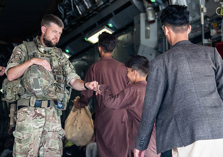A handout photo released on August 23, by the British Ministry of Defence, shows members of the UK Armed Forces taking part in the evacuation of  from Kabul airport. 
