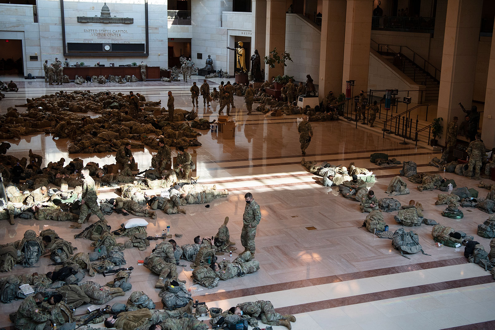 Members of the National Guard rest in the Capitol Visitor Center on January 13.