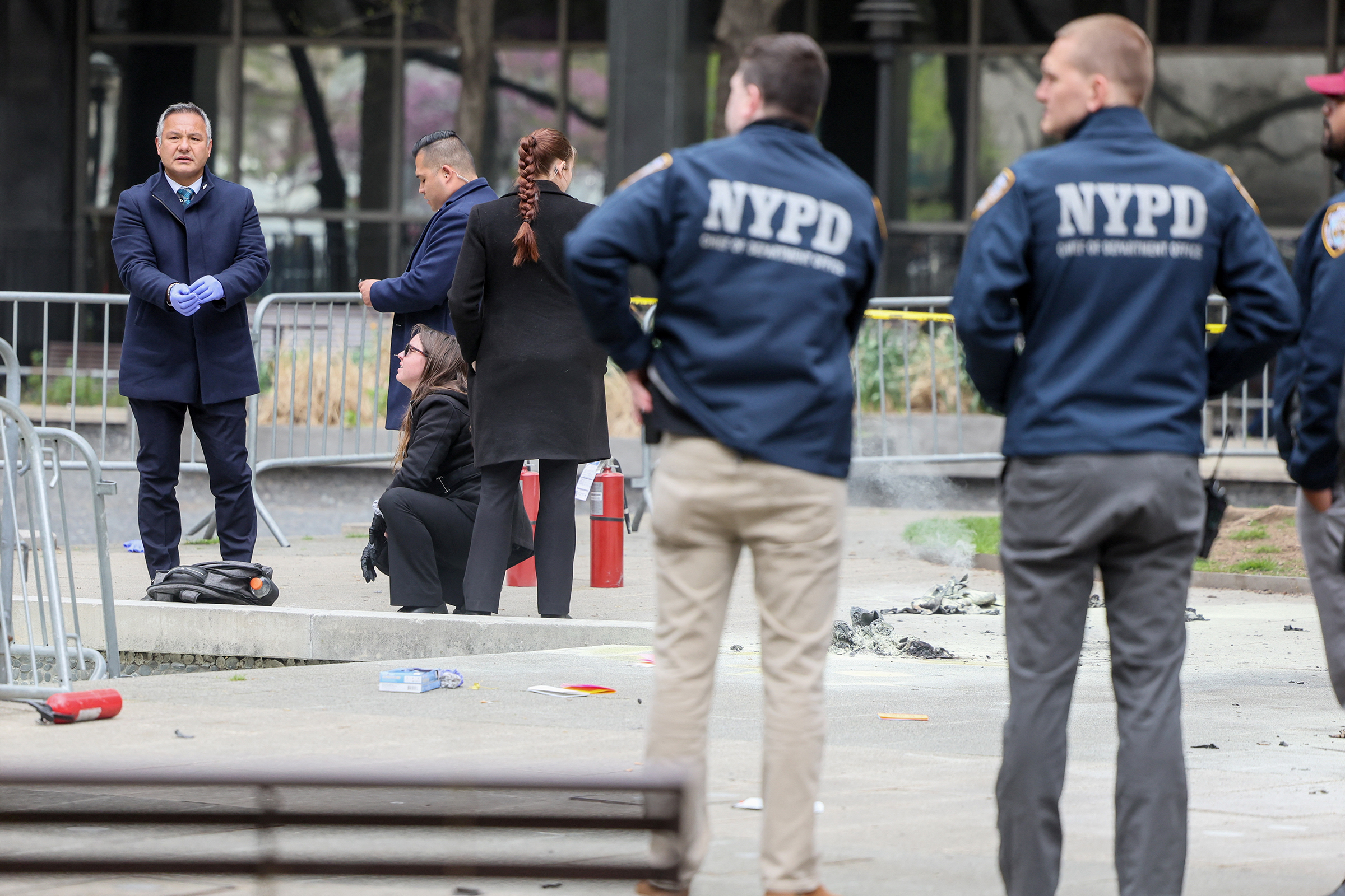 Emergency personnel respond to a report of a person covered in flames outside the courthouse where former President Donald Trump's criminal hush money trial is underway on Friday in New York.