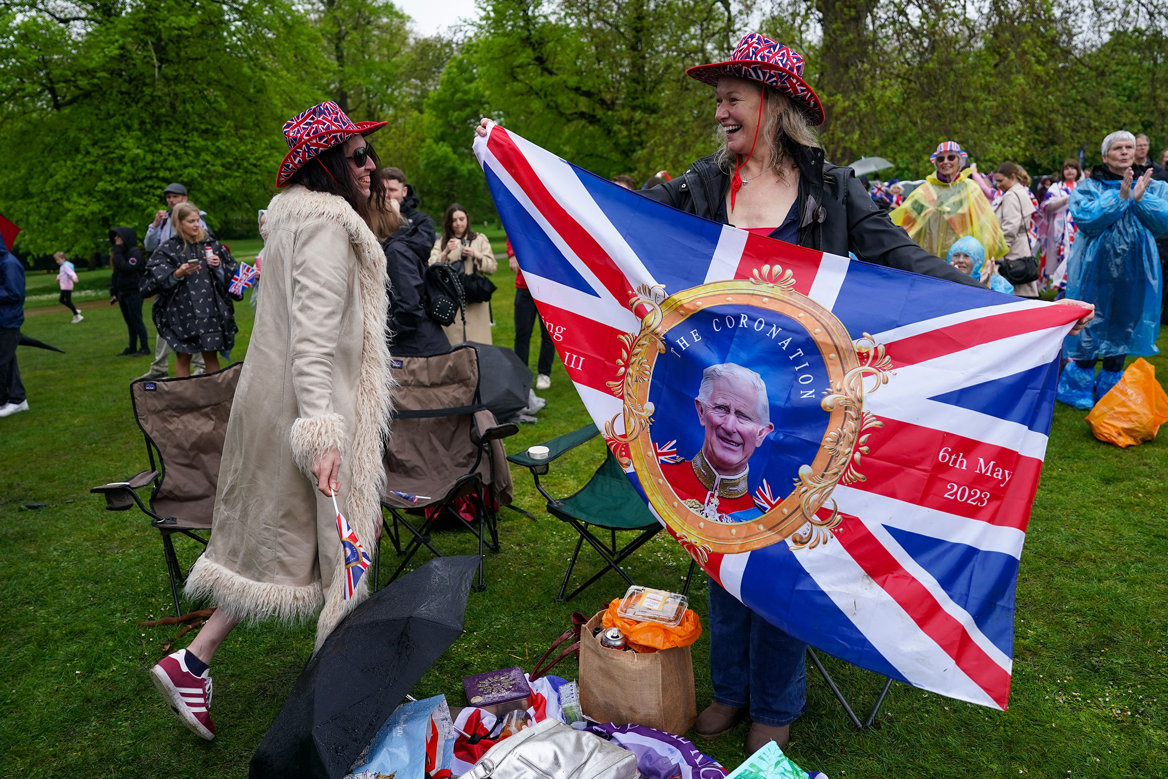 Members of the public in Hyde park react as they watch the the Coronation of King Charles III and Queen Camilla.