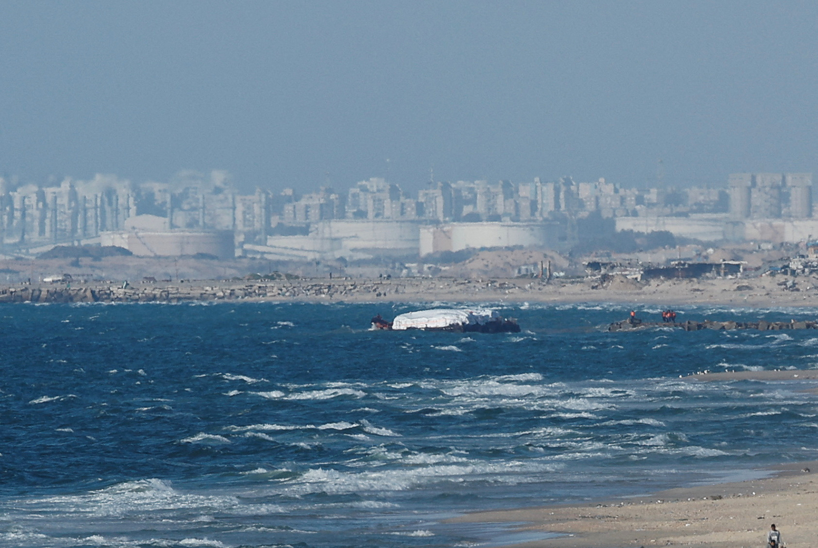Aid delivered by the Open Arms vessel arrives off the coast of Gaza, amid the ongoing conflict between Israel and the Palestinian Islamist group Hamas, as seen from central Gaza Strip on March 15.
